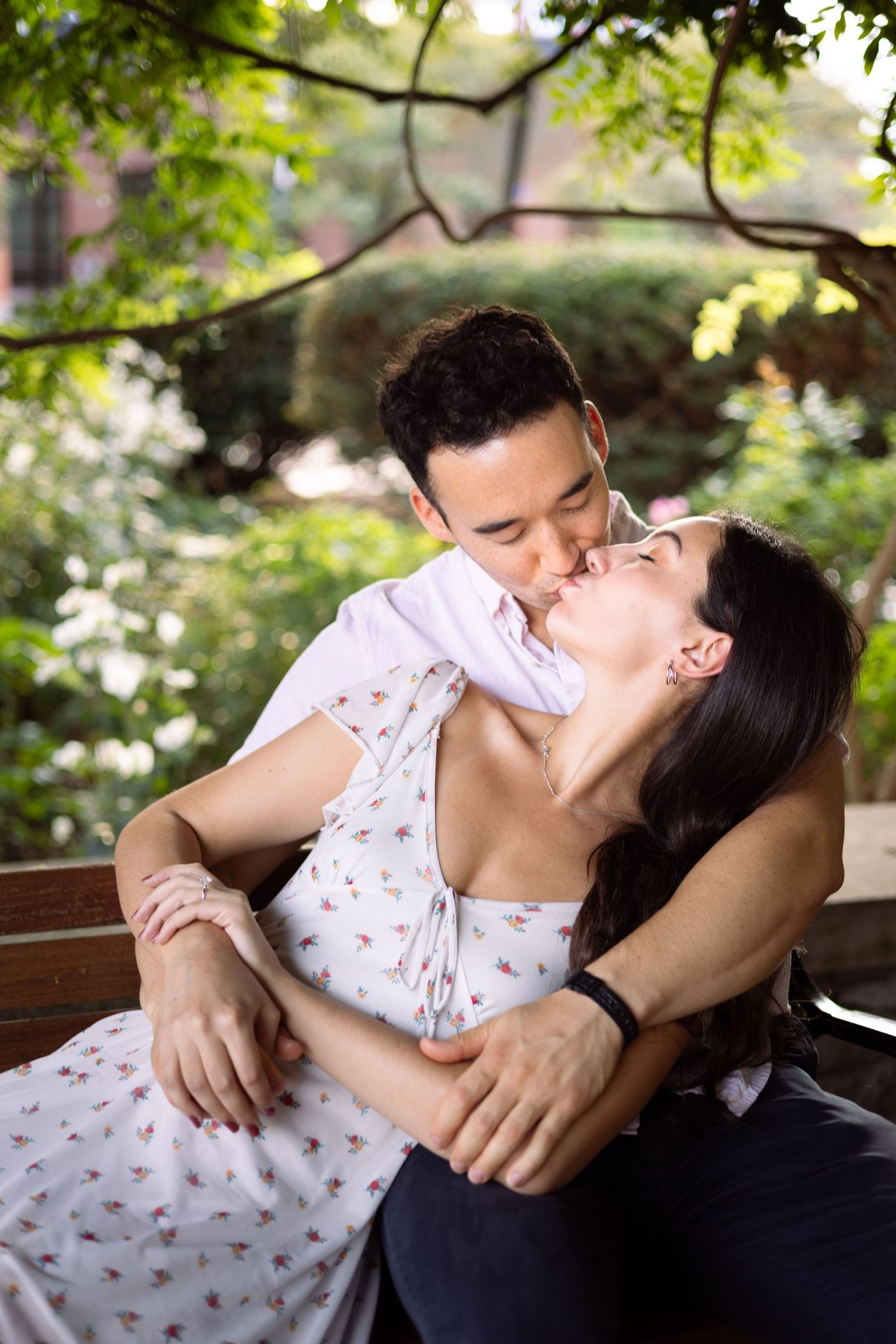 Couple kissing on park bench photography