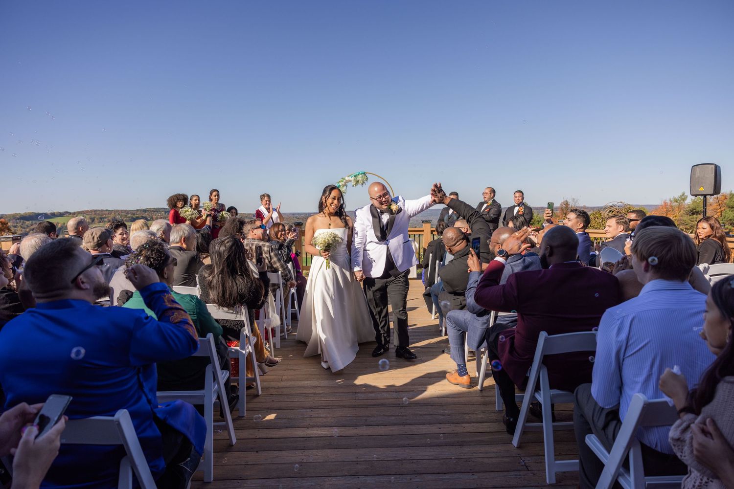 Newlyweds celebrating recessional outdoor ceremony photography