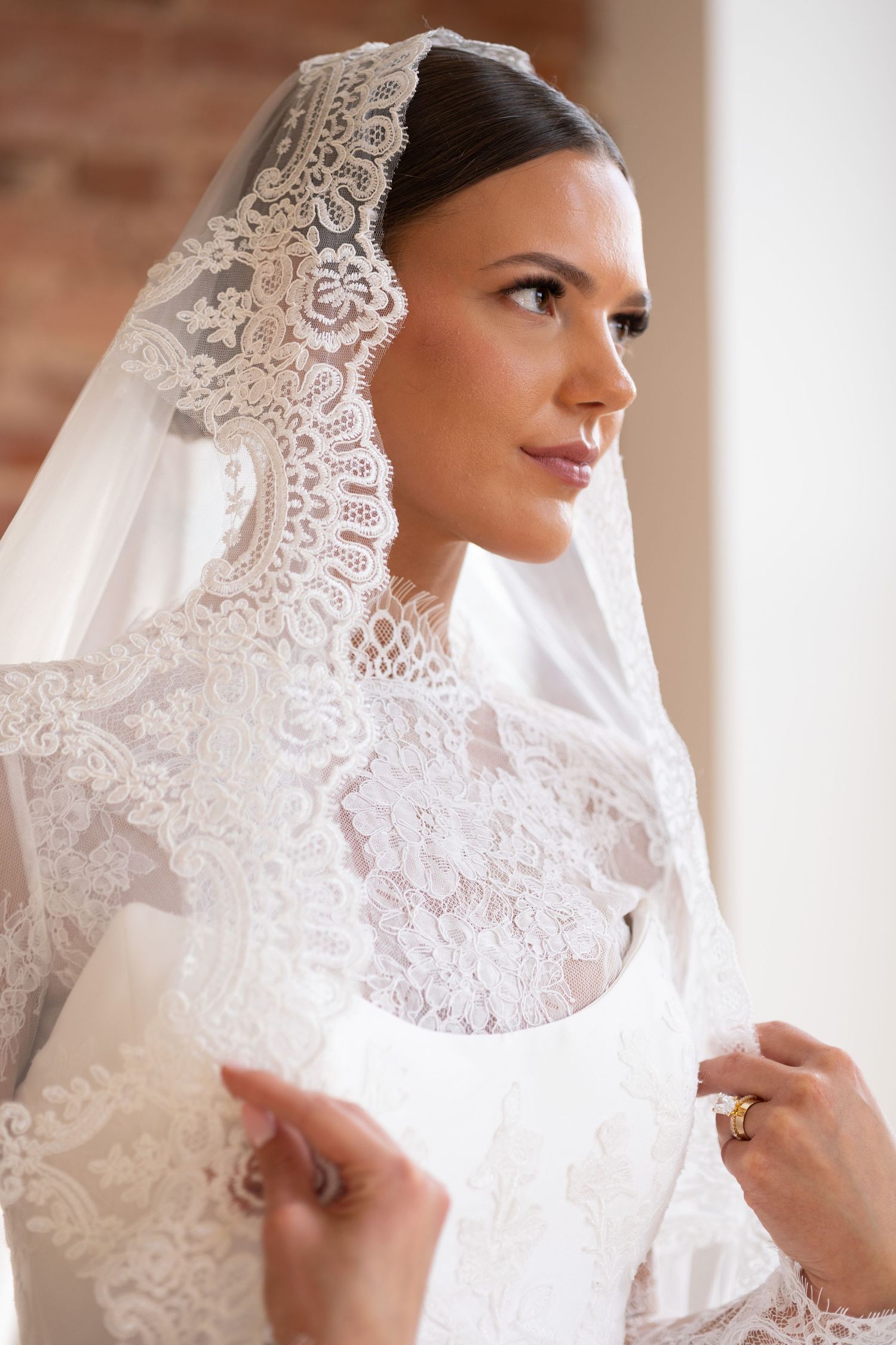 Bride wearing lace veil closeup photography