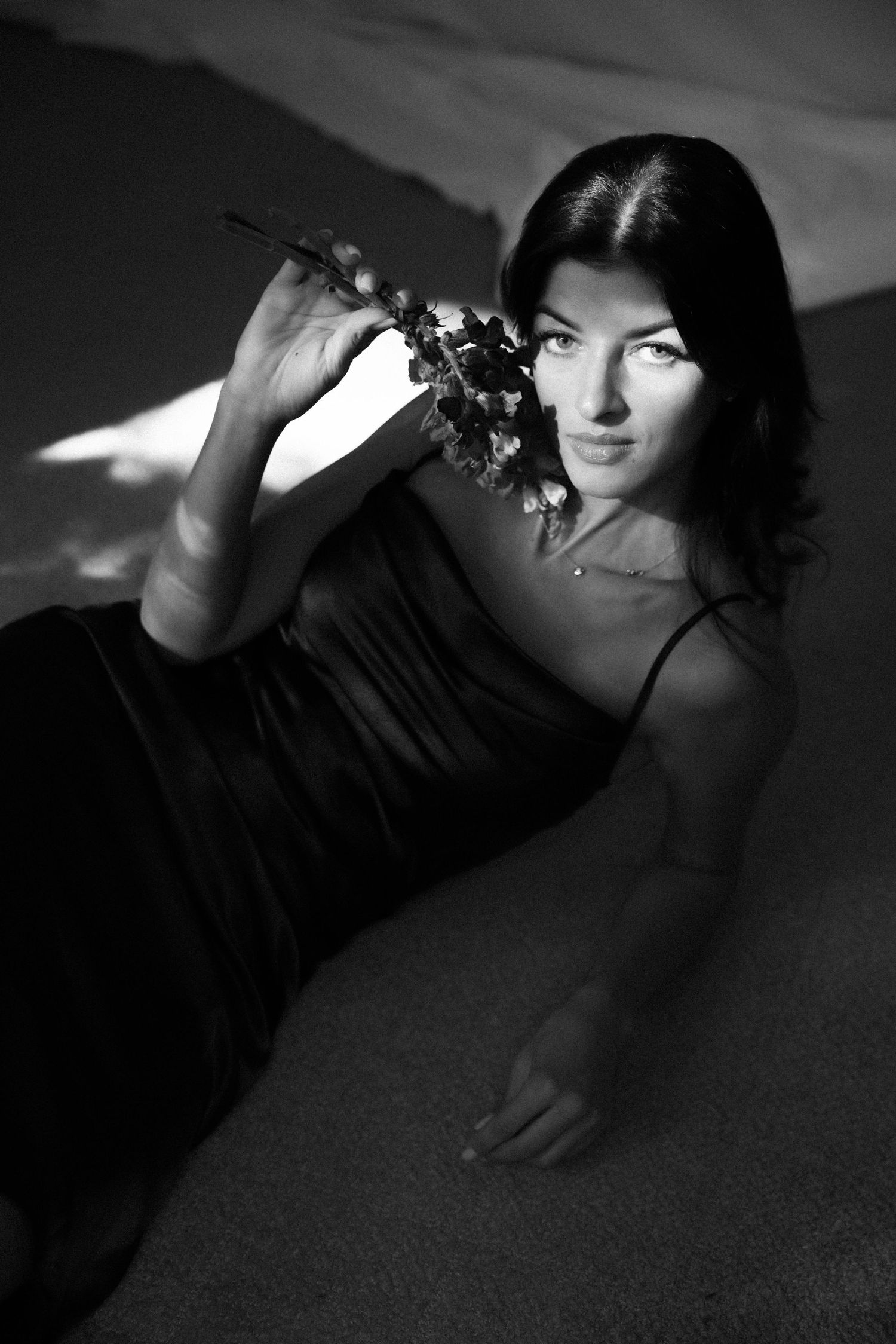 Woman holding flowers black white photography