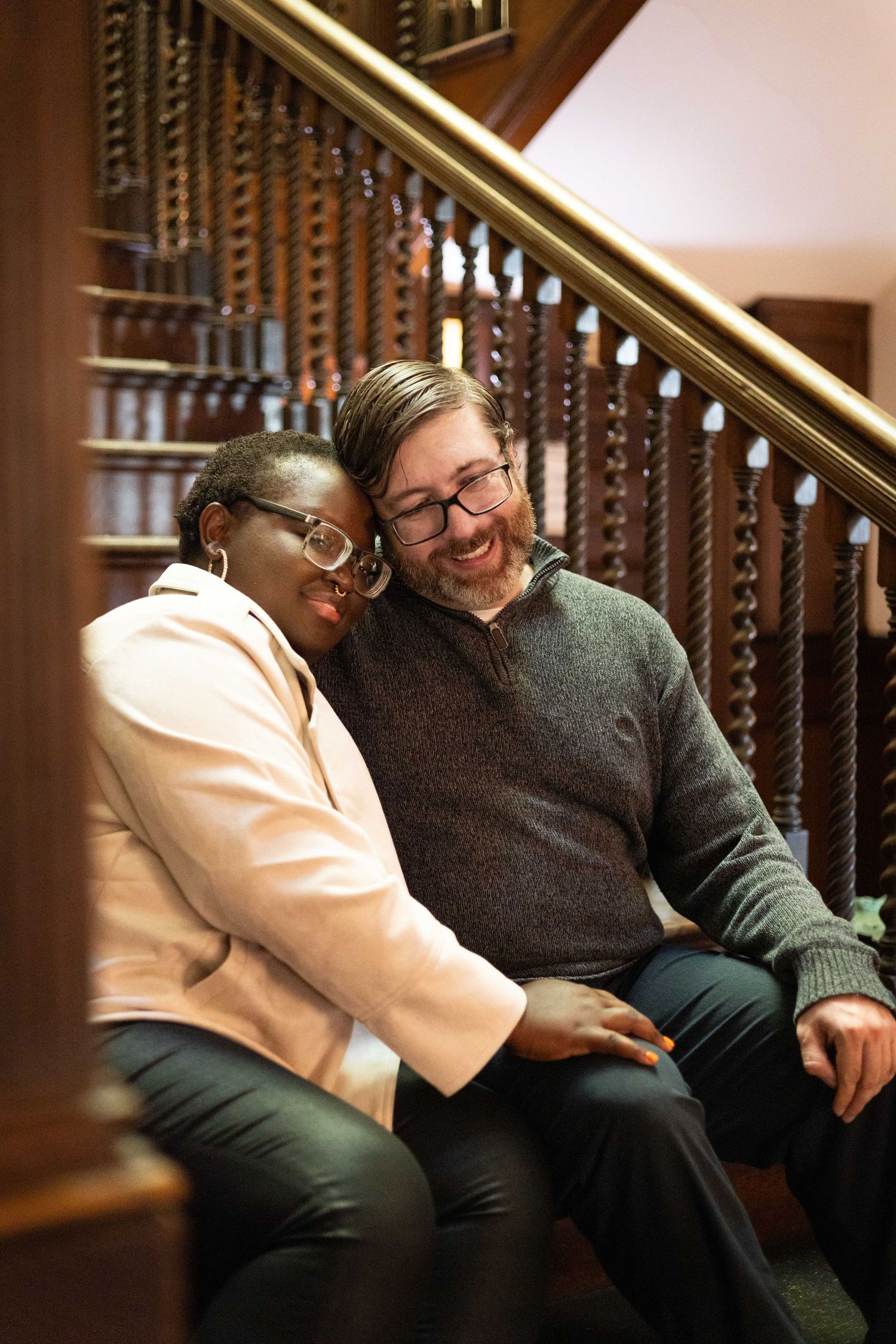 Couple laughing on staircase indoors photography