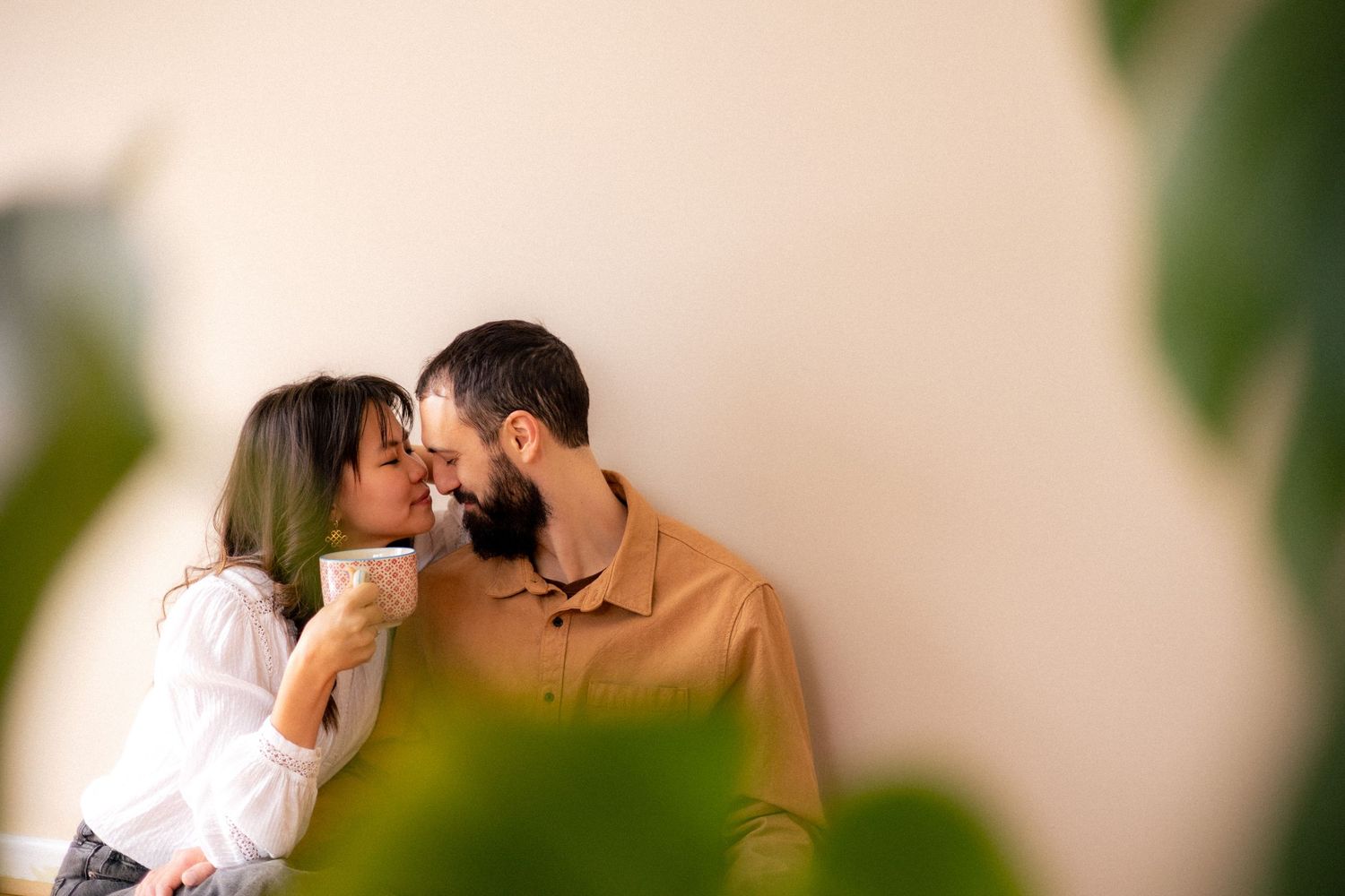 Couple kissing indoors with coffee photography
