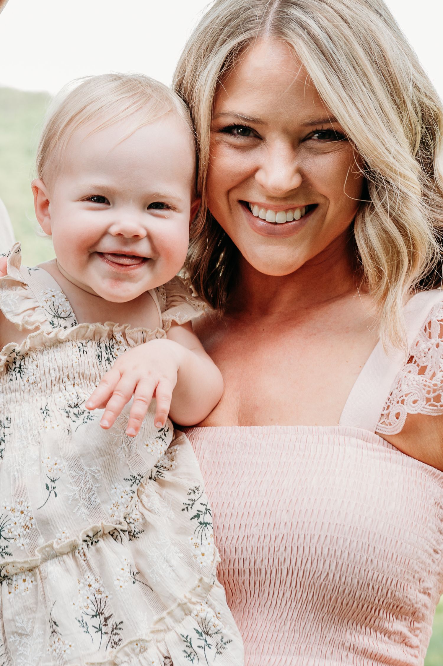 Sweet moments shared in matching pink outfits against a light background.