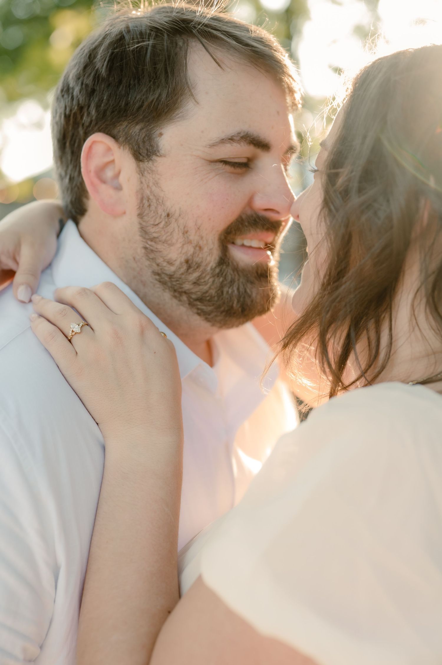 Close-up romantic shots of a couple sharing intimate kisses in soft natural lighting.