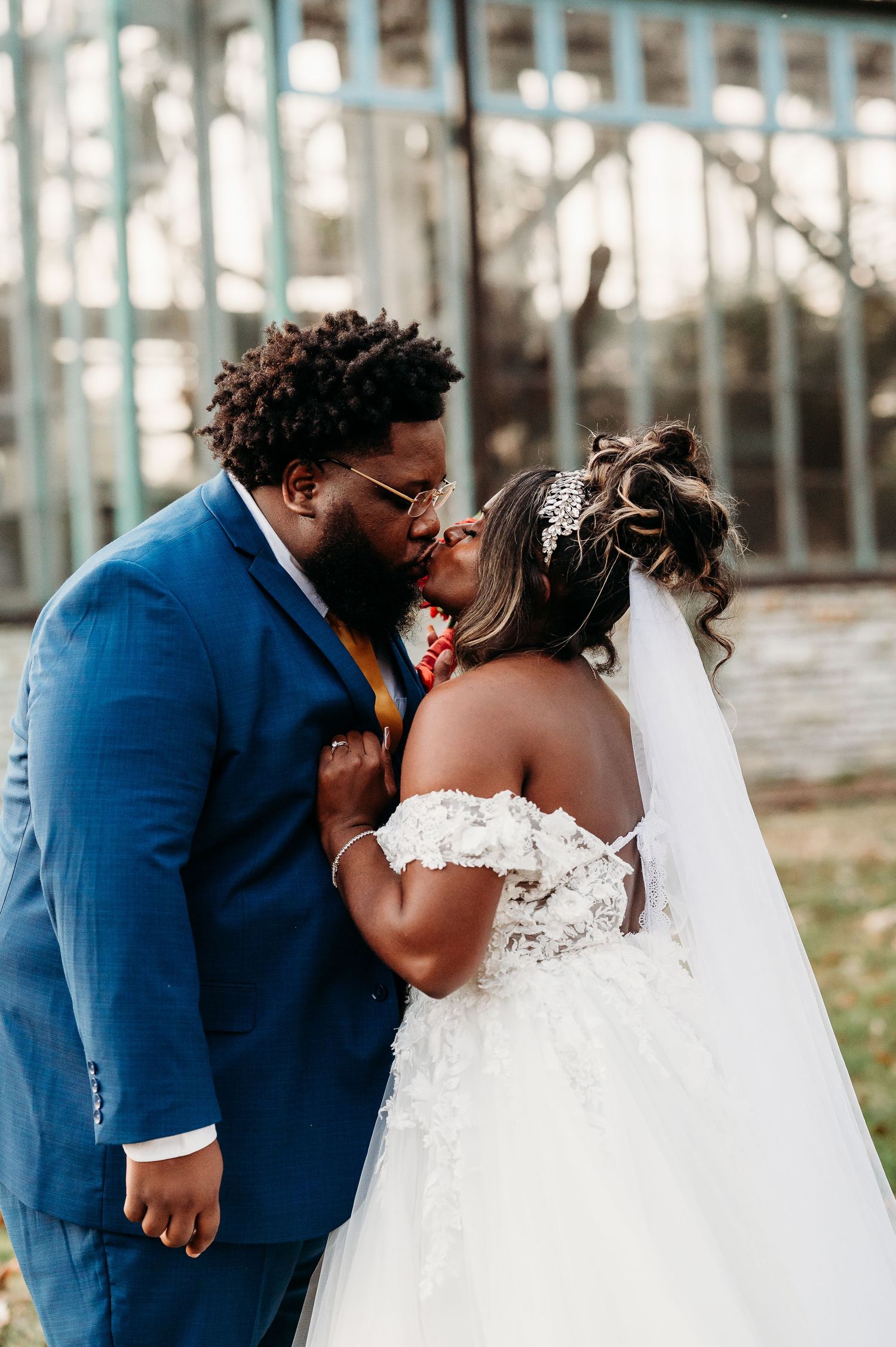 Wedding couple shares intimate moments in front of tropical palm trees.