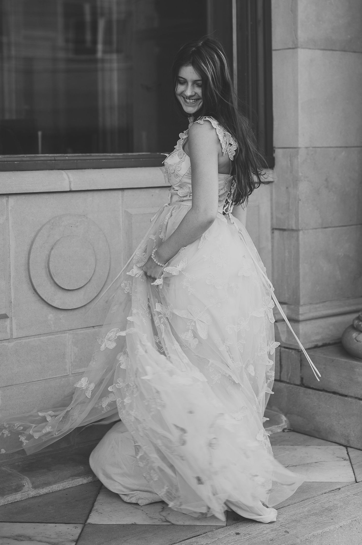 Black and white photo series showing flowing wedding dress details and movement.