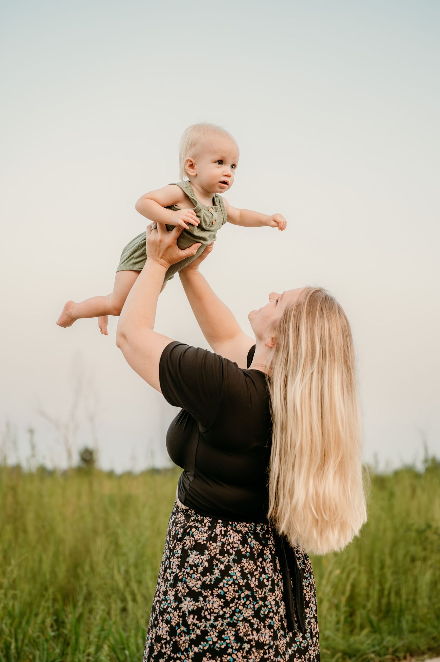 Mom and baby playing together in a grassy meadow during sunset, shown in a collage of three joyful moments. Captured by Jessica Sagerty