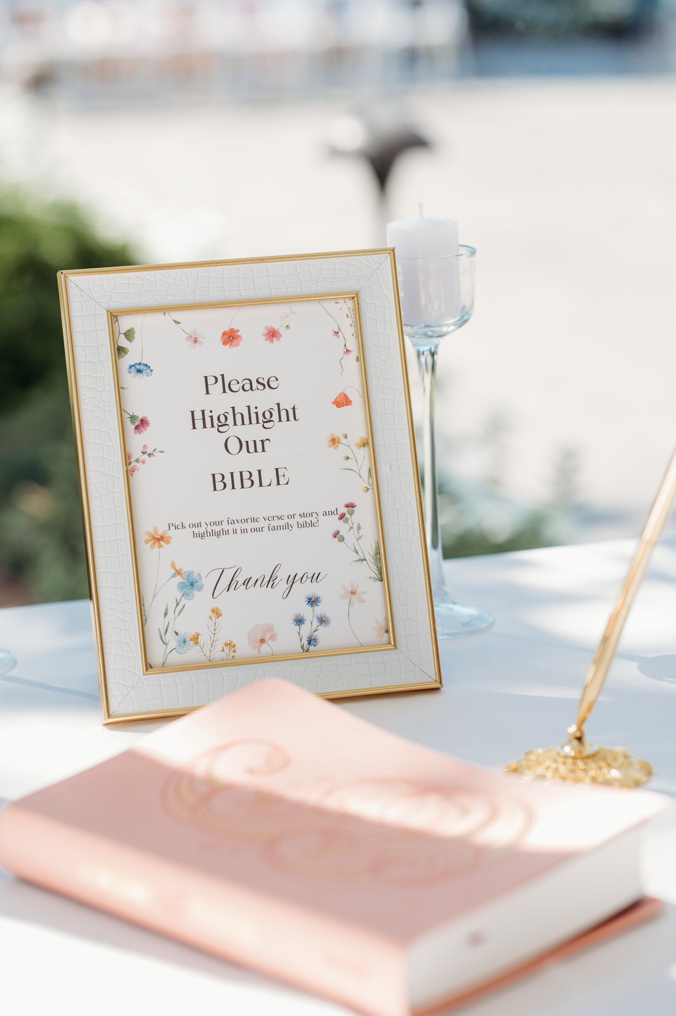 Wedding guestbook sign with floral border asking guests to highlight Bible verses.