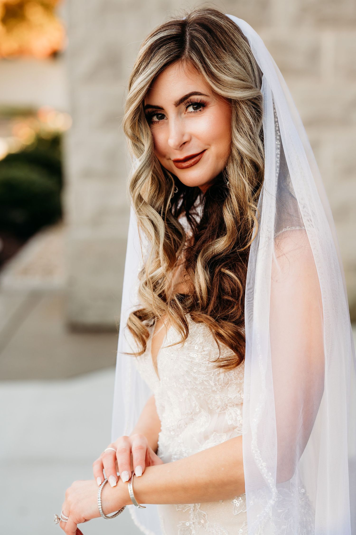 Portrait sequence of bride wearing delicate veil and lace wedding dress.