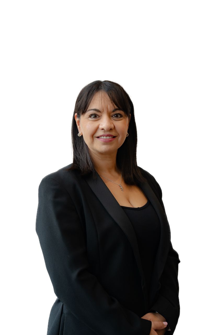 Professional woman in black blazer smiling confidently against white background, ideal for business or corporate profile.