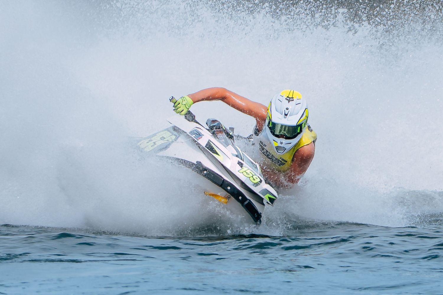 A jet ski rider performs an extreme maneuver creating a dramatic splash of water during a competition in Christchurch.