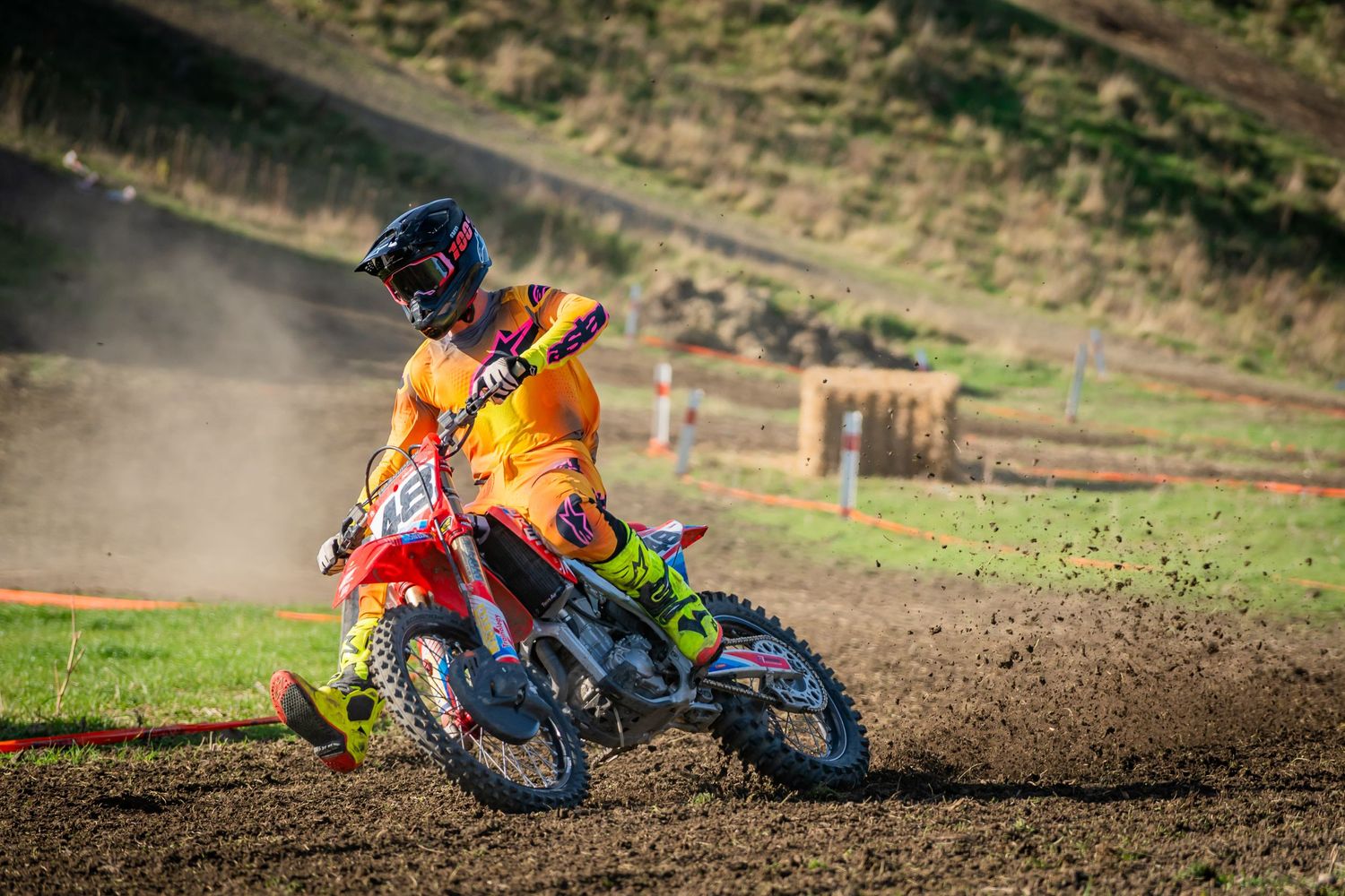 Motocross rider on KTM dirt bike leans into turn on dusty track during intense racing action at the Michael Godfrey Memorial Race 2025.