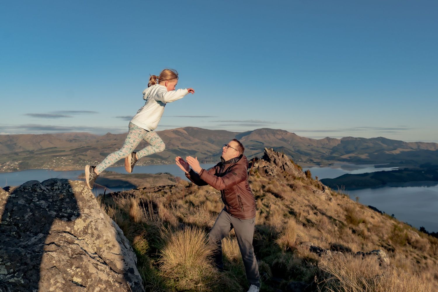 Father and daughter enjoy a fun moment in the Port Hills, Christchurch.