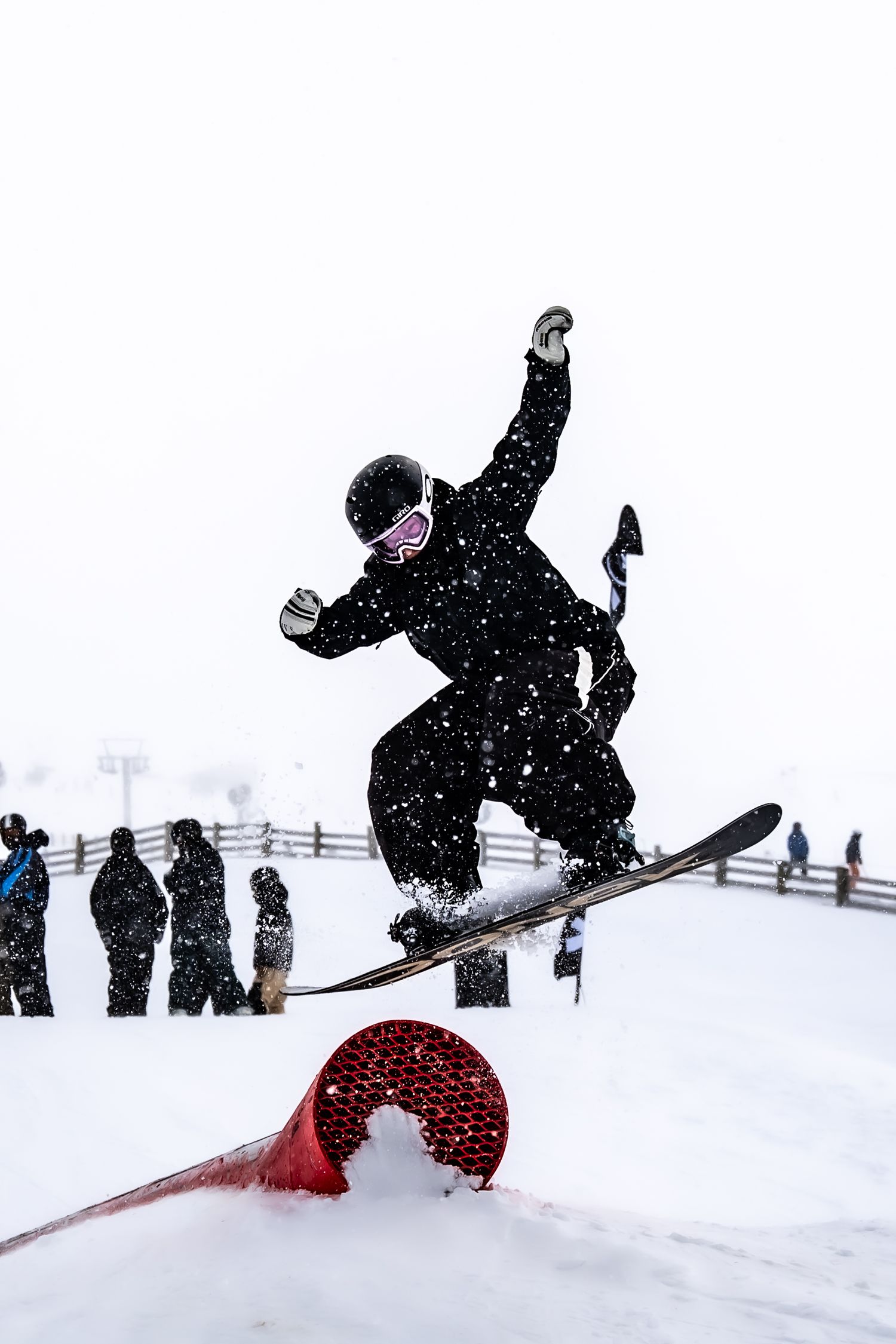 A sequence of snowboarders performing aerial tricks and jumps in snowy winter conditions on a mountain slope at Cardrona Alpine Report.