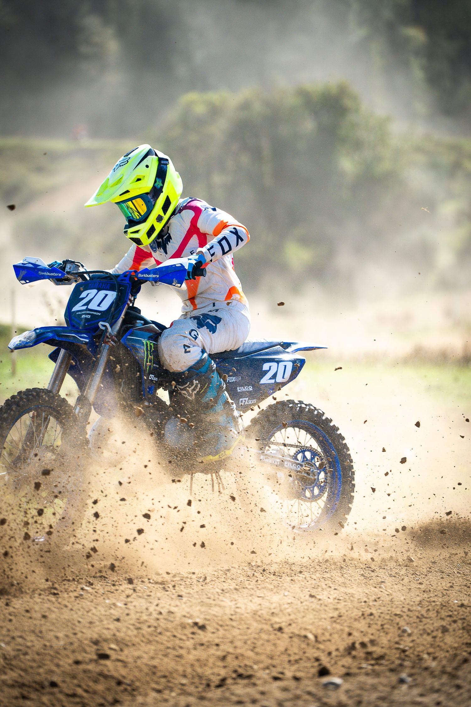 Dirt bike spraying rooster tails of soil while racing through a challenging motocross course on the West Coast of the South Island, NZ.