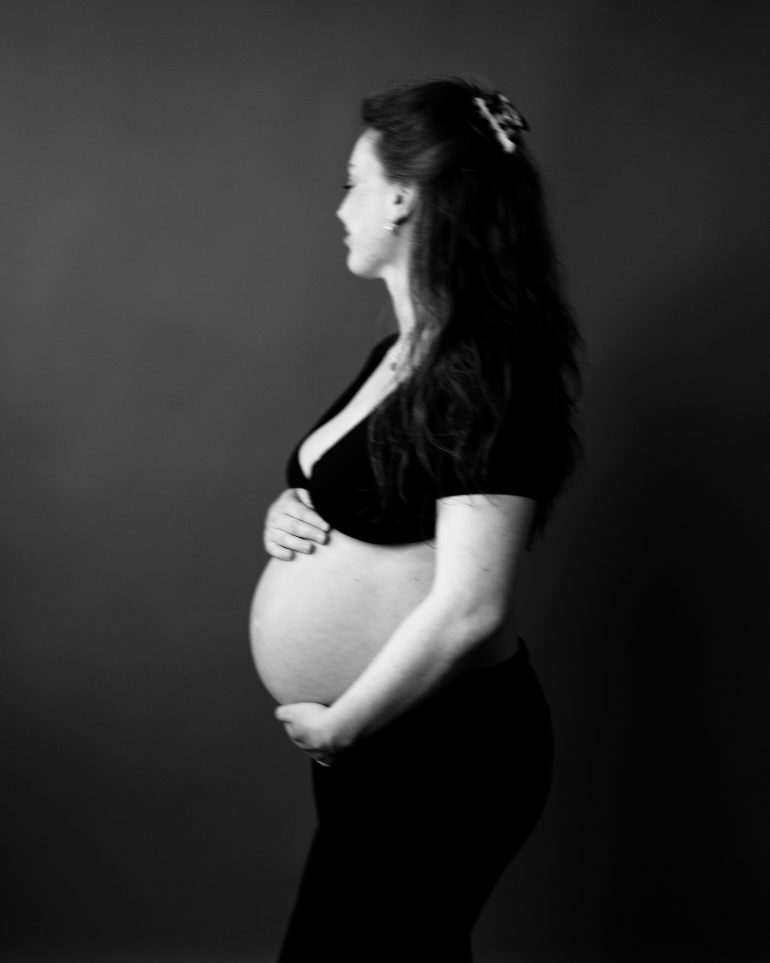 Black and white maternity portrait series showing pregnancy progression.