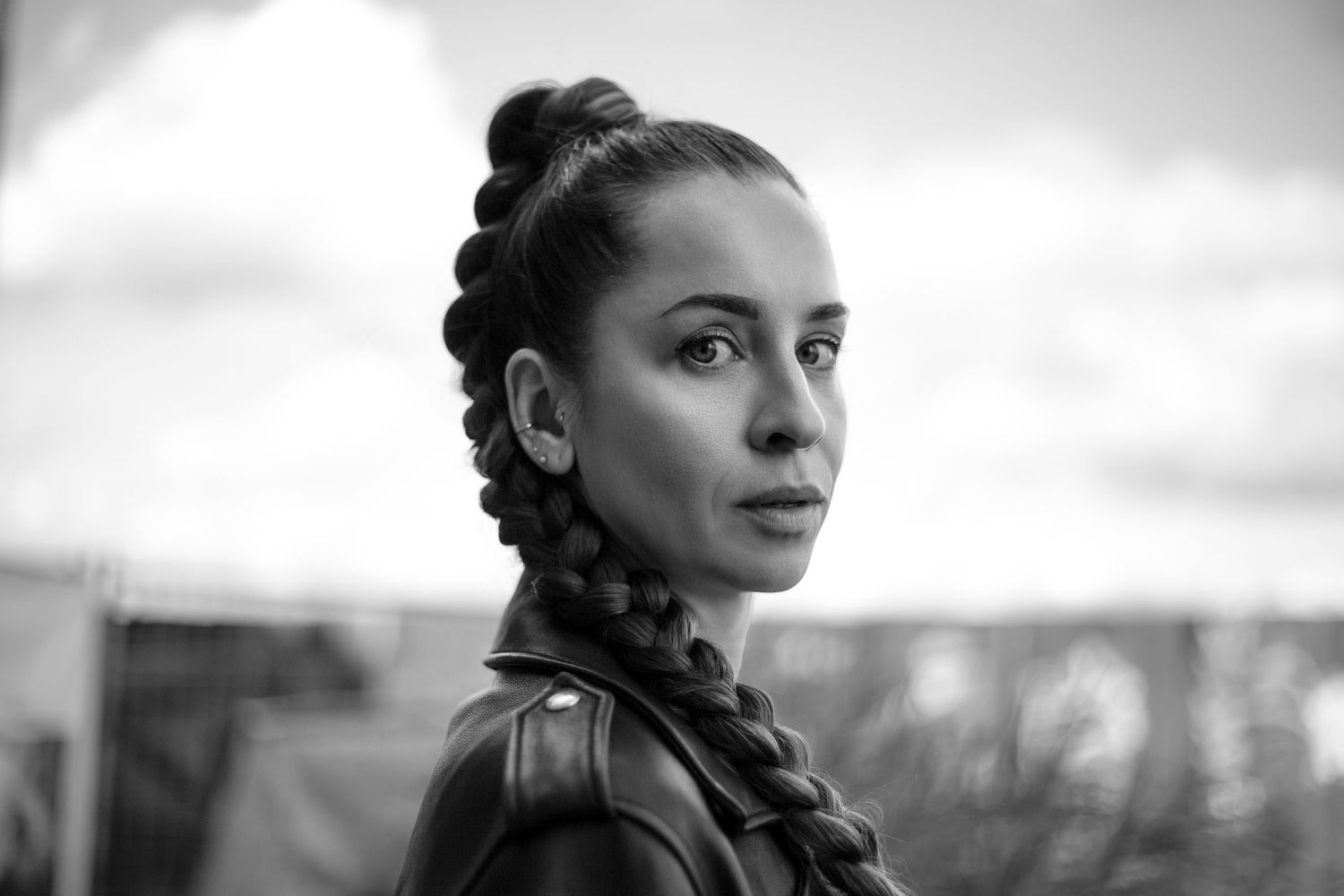 A black and white collage of artistic portraits showing different emotional expressions and poses.