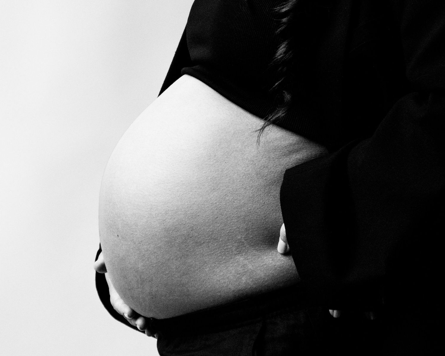 A dramatic black and white silhouette portrait showing a person's profile against a stark white background.