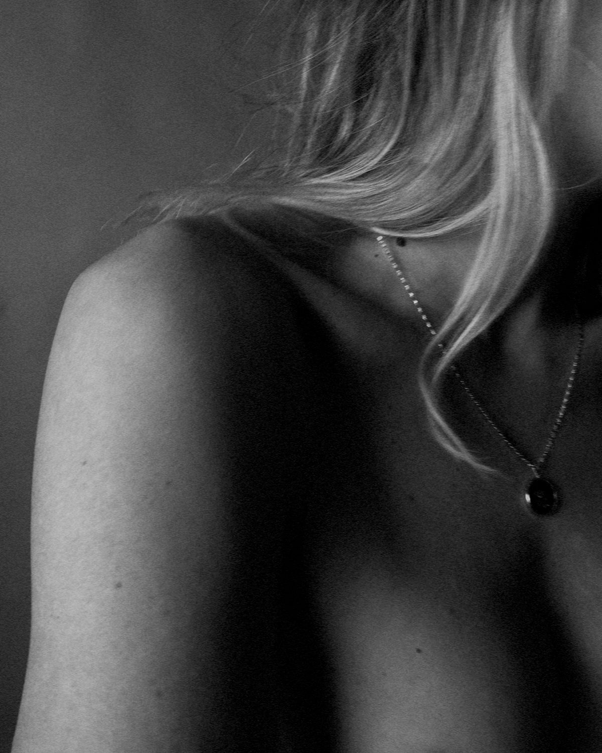 A series of black and white artistic photographs showing close-up views of a person's neck and shoulders.