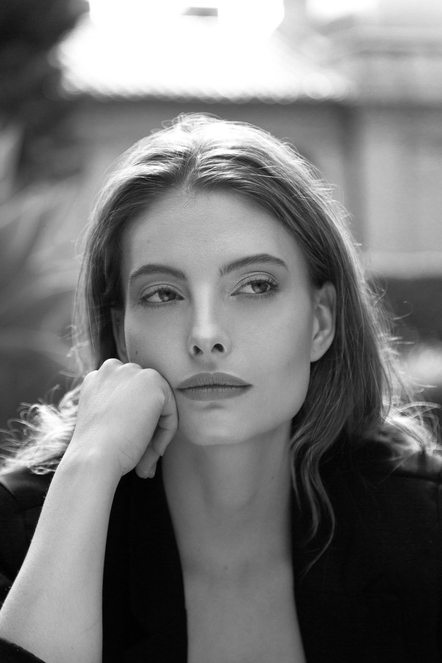 Artistic black and white portrait series showing dramatic angles and lighting in a cinematic style.