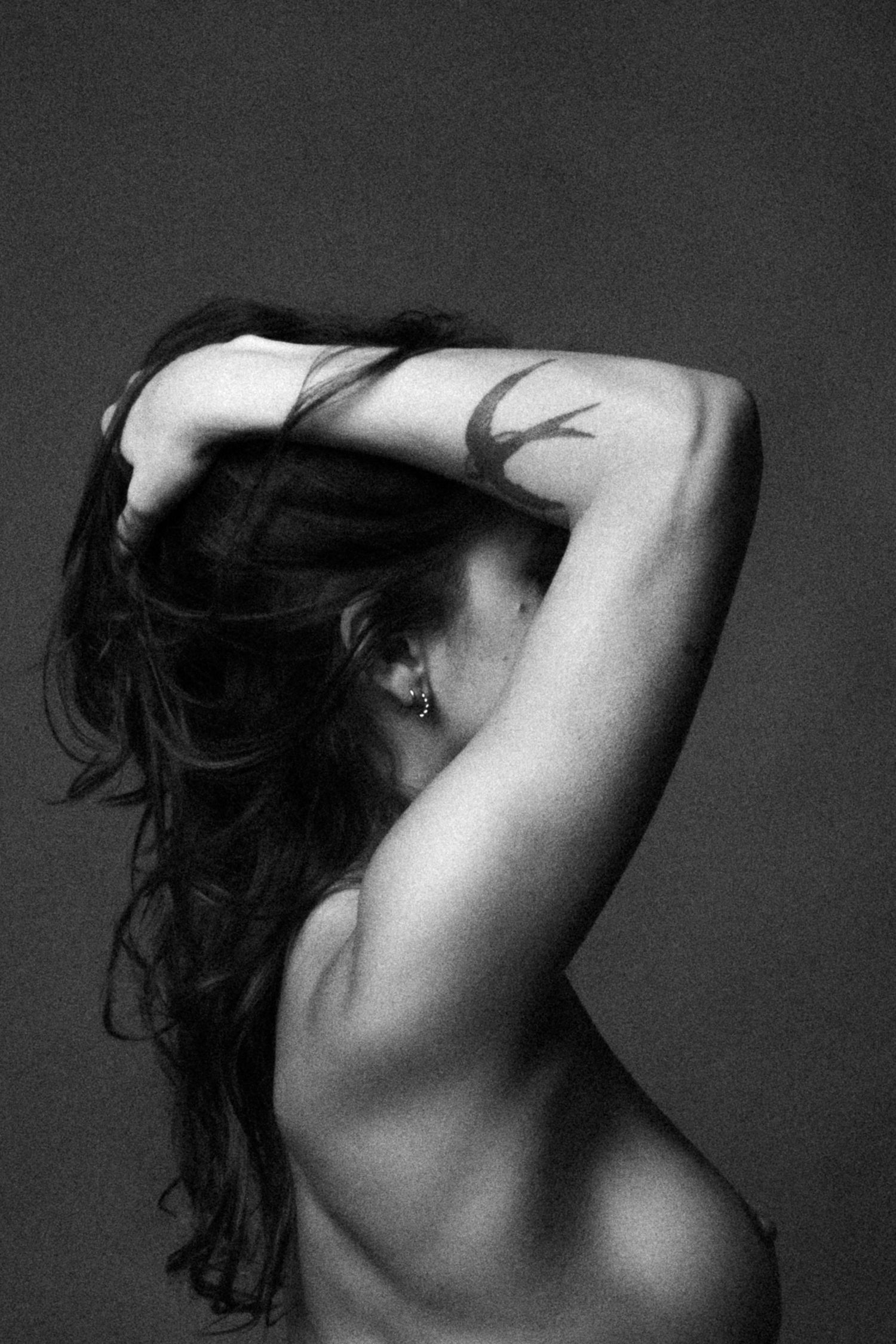 Artistic black and white nude study showing graceful back poses.