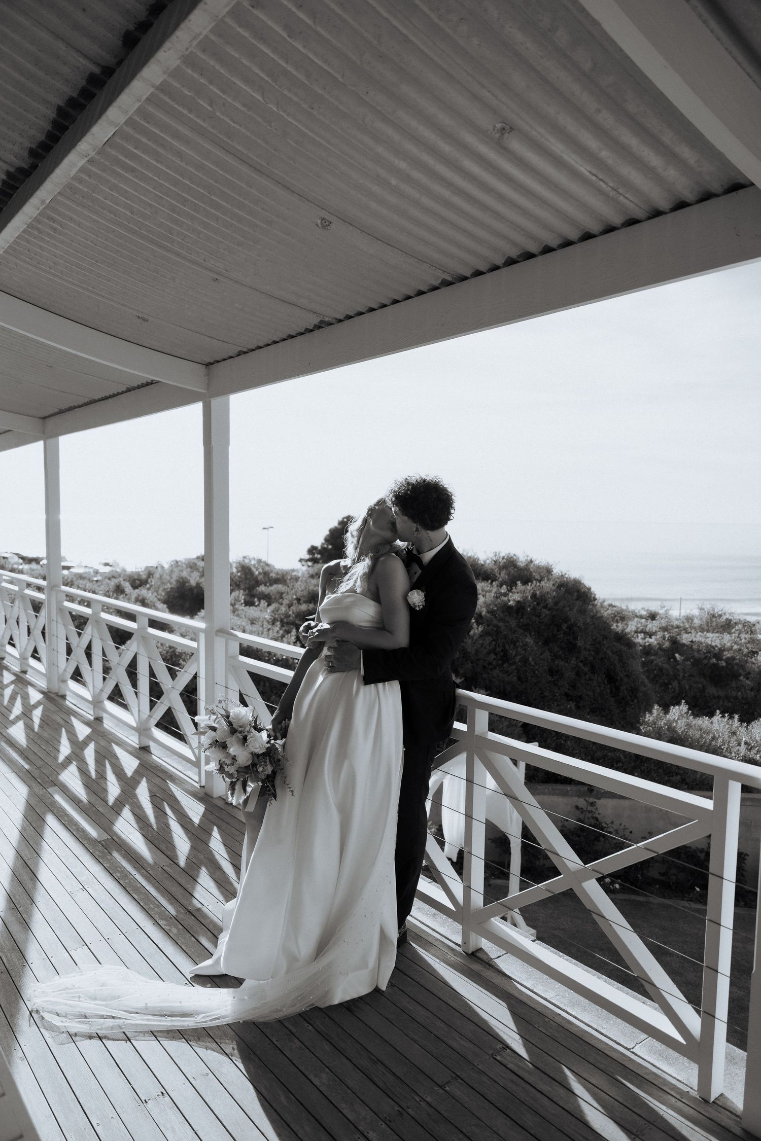 Black and white wedding portrait on coastal deck with ocean view at the Alton house wedding, Port Willunga images by braytmedia