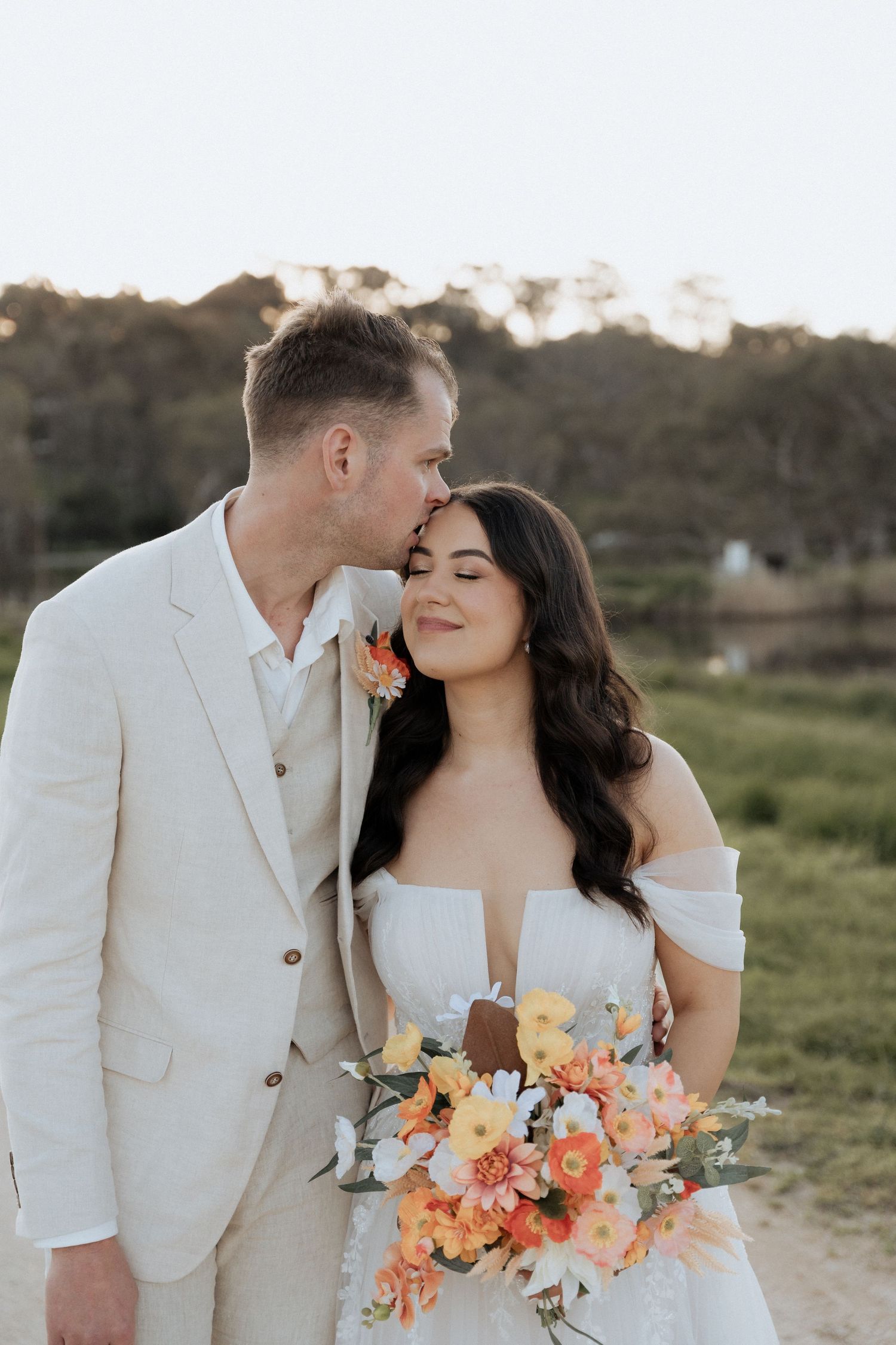 A romantic wedding couple embrace at Howard’s vineyard, Adelaide hills captured by Braytmedia