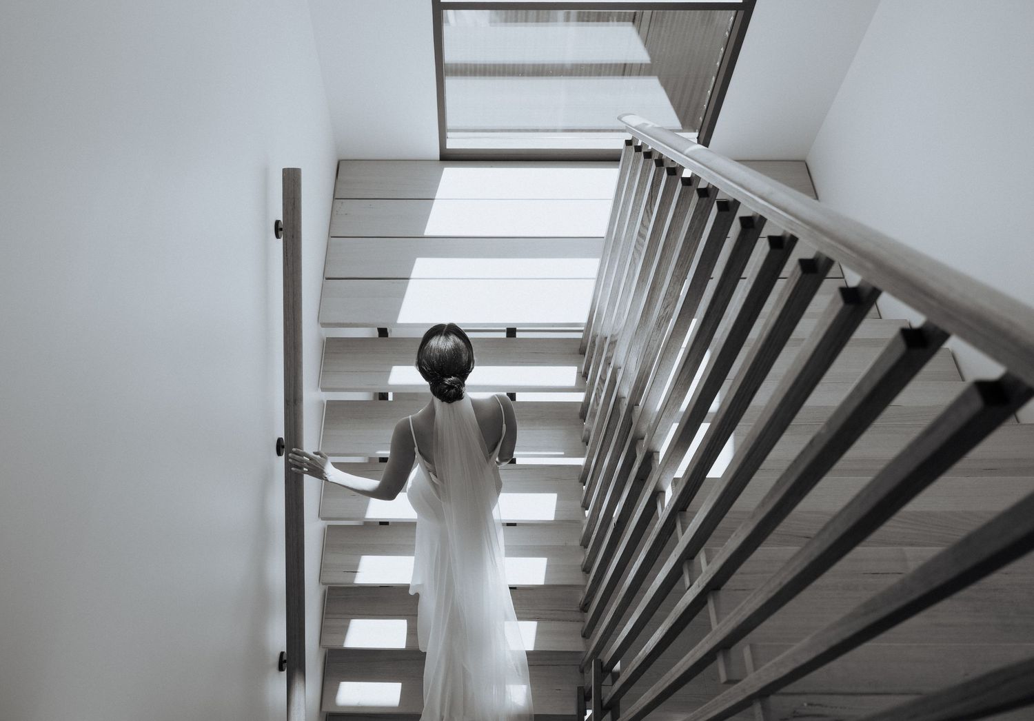 Architectural detail of modern white staircase with clean lines and natural lighting.