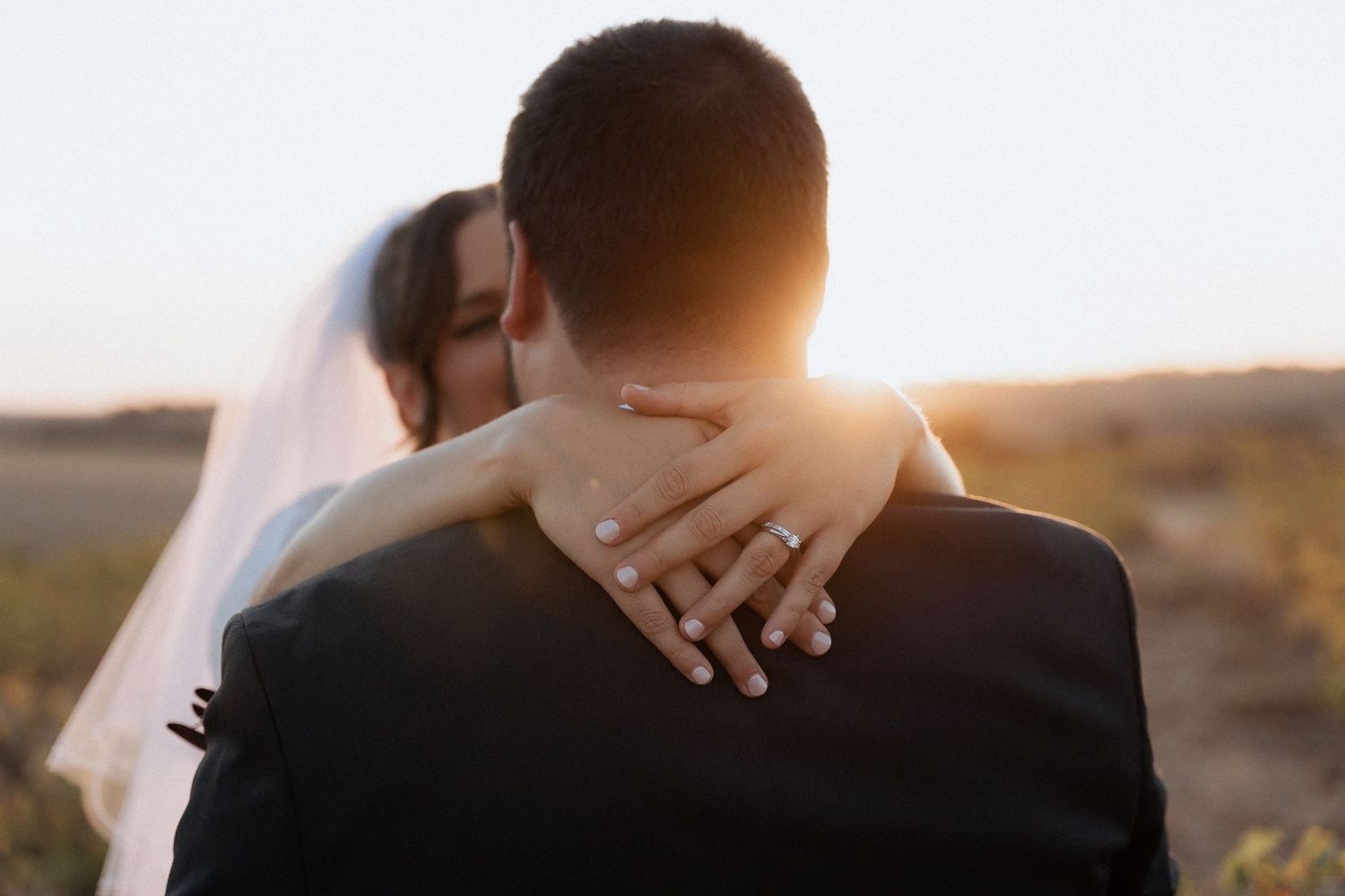Intimate sunset wedding portraits with golden backlight.