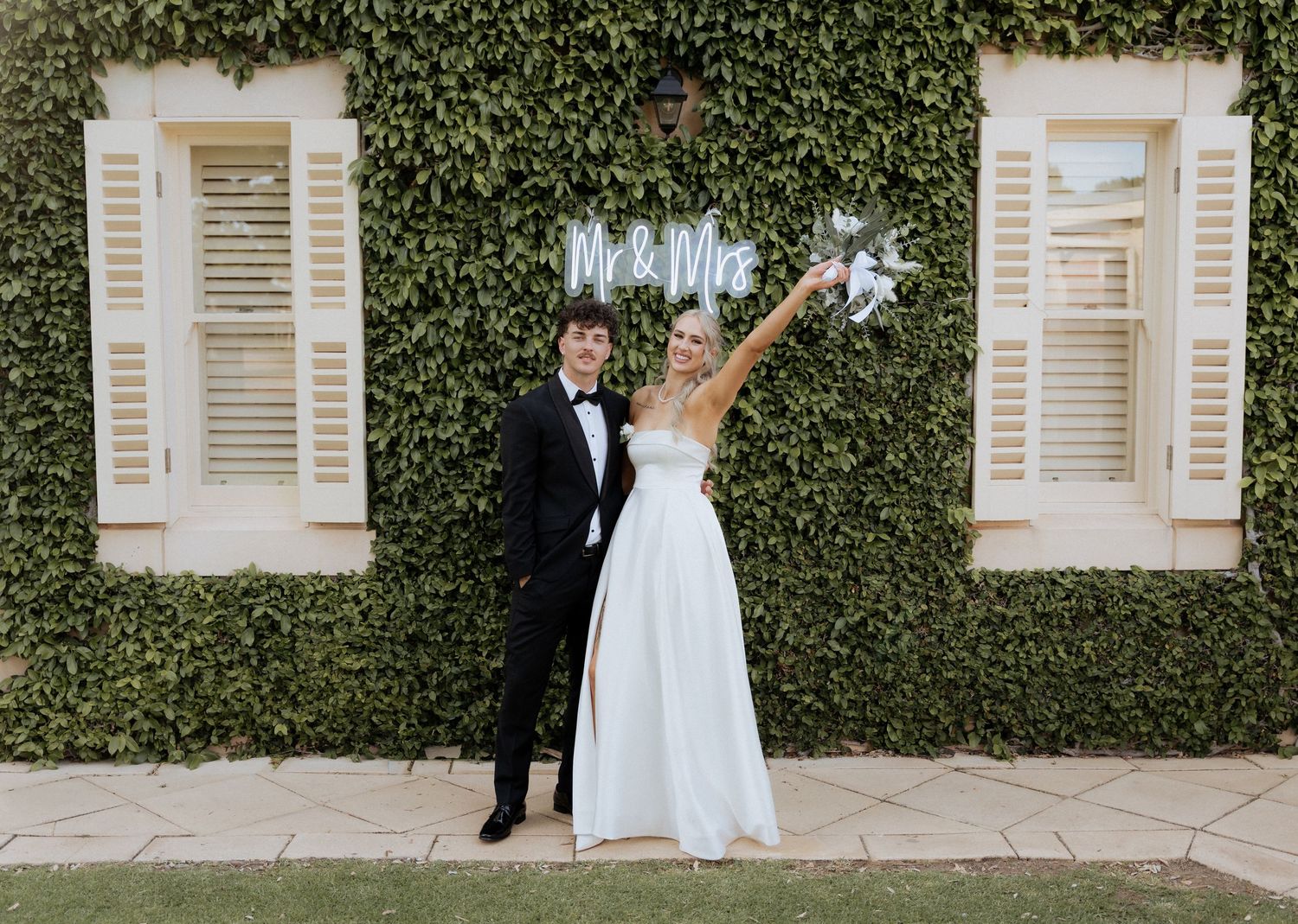 Wedding portraits against an ivy-covered wall with white shuttered windows, images by braytmedia at the alton house wedding
