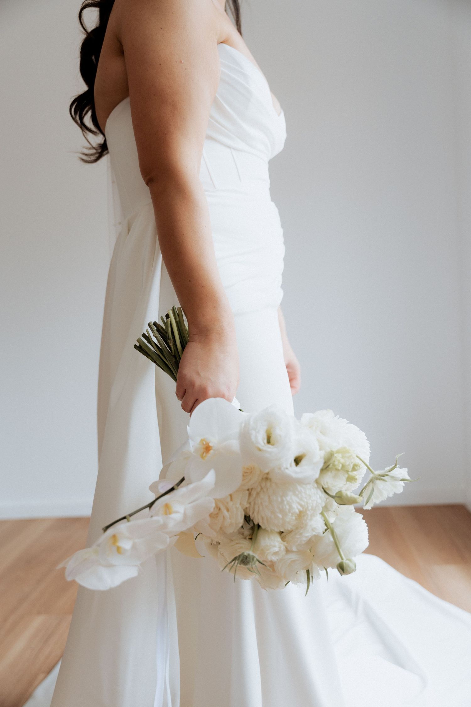 Close-up details of a white wedding dress with floral bouquet.Lot100 wedding venue images by Braytmedia. Adelaide
