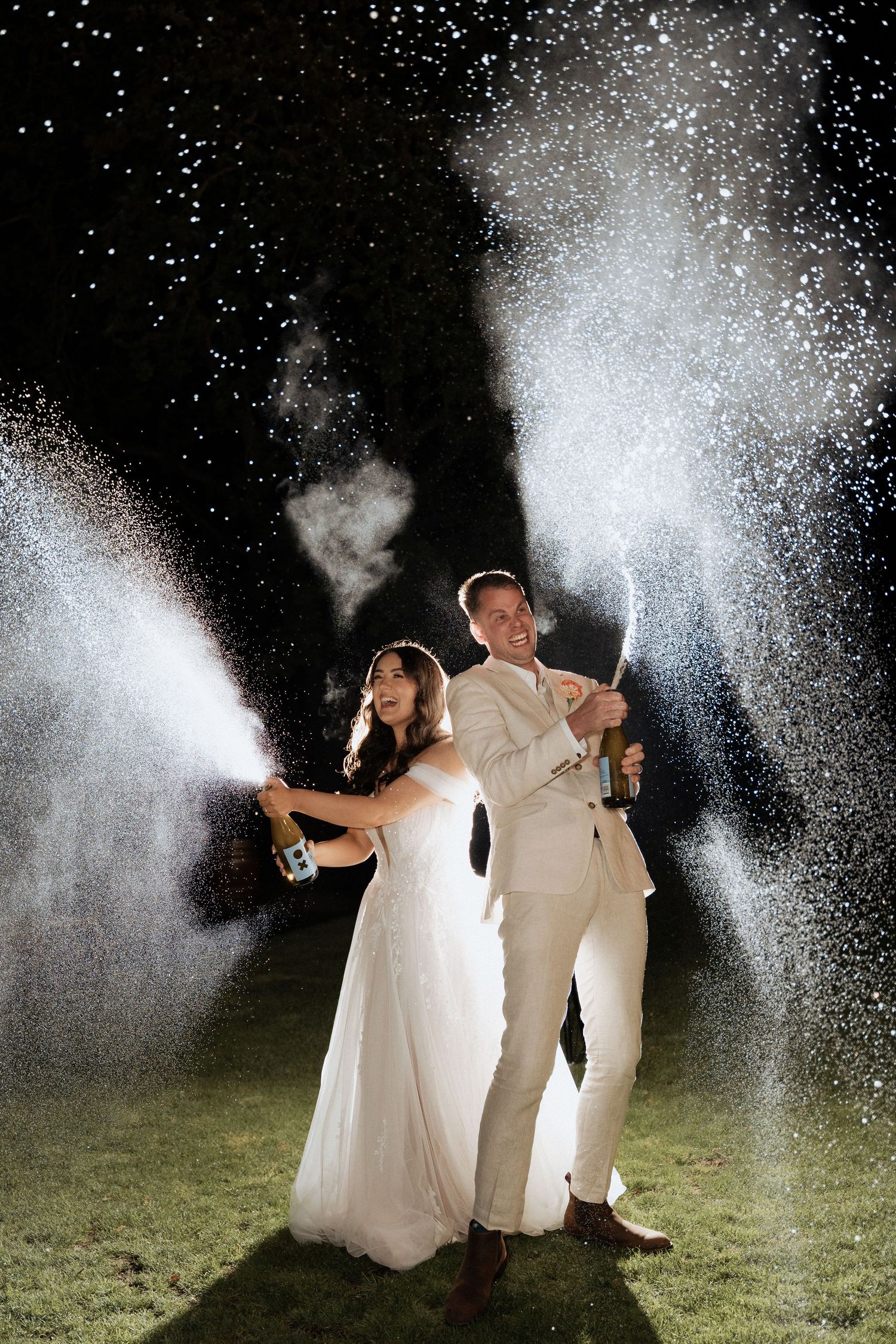 A wedding couple sprays champagne in a playful sequence of nighttime celebration photos creating sparkly effects.