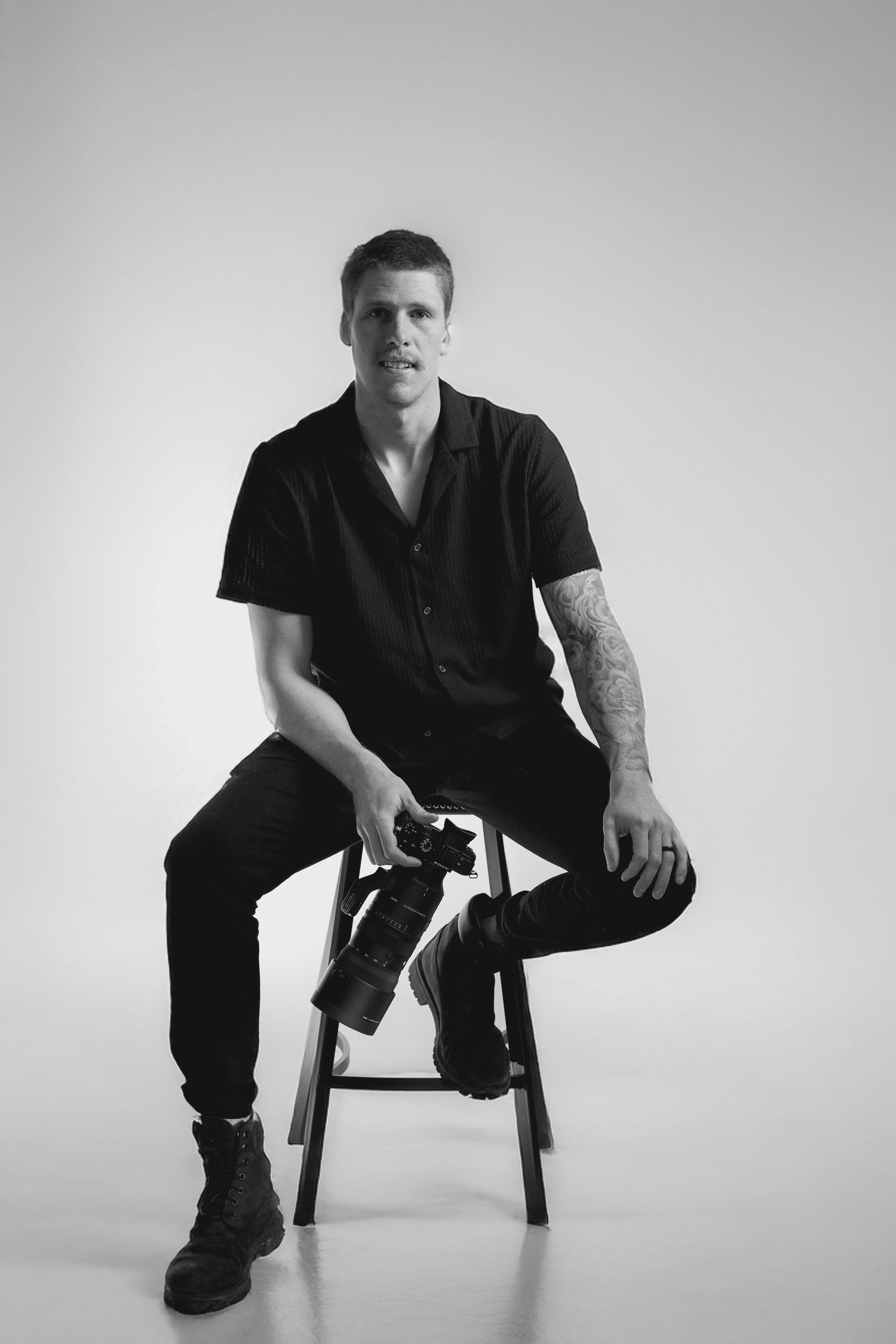 Black and white portrait series of someone sitting on a chair in various poses.