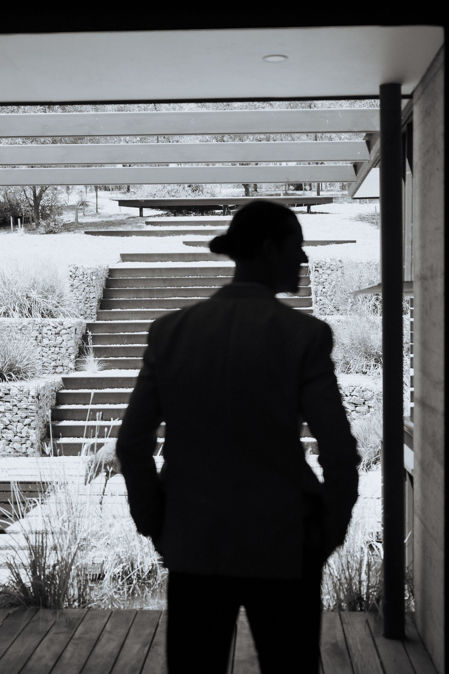 Silhouettes against a bright window frame creating dramatic contrast and shapes.