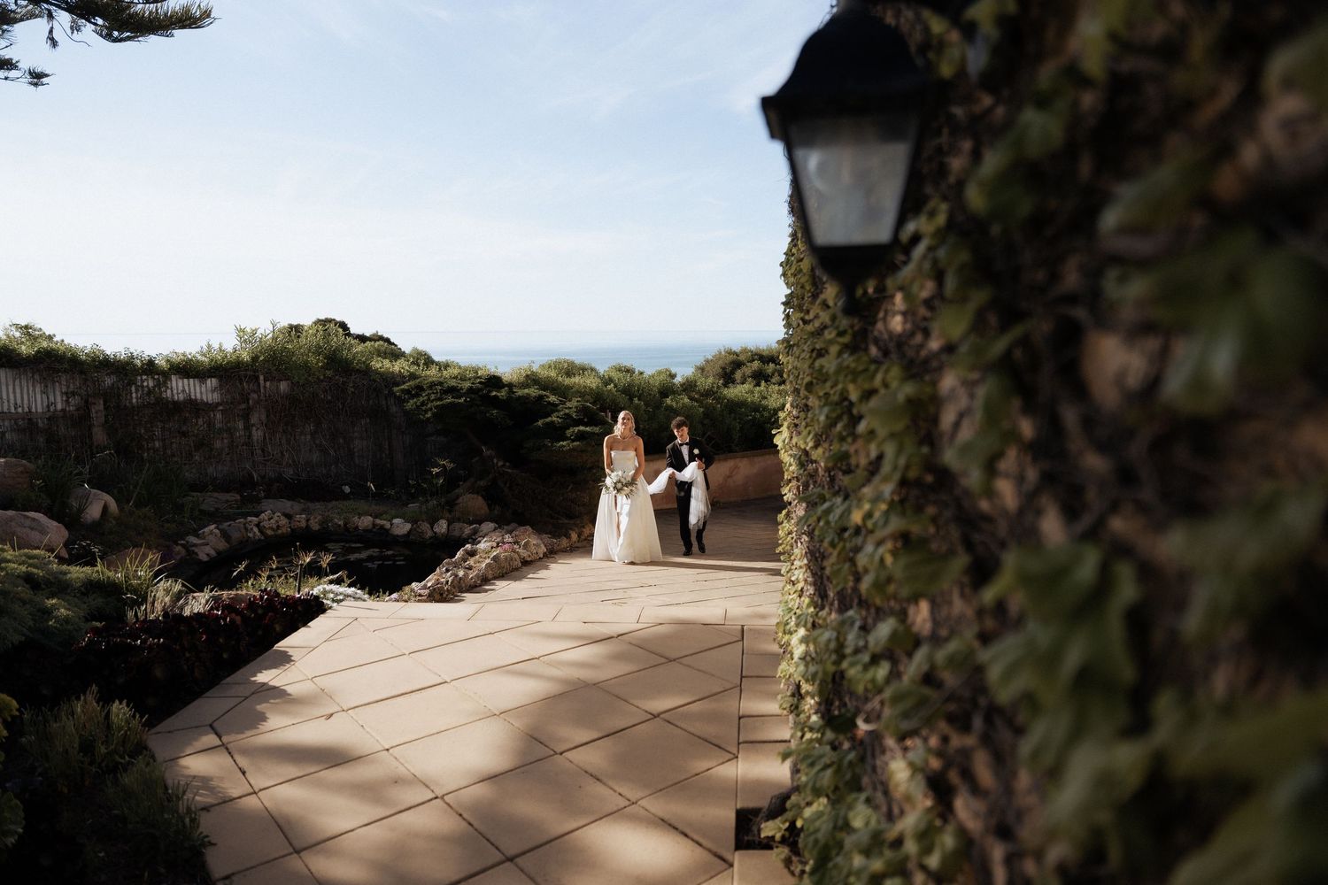 Elegant outdoor wedding ceremony venue with stone pathway and ivy-covered walls by braytmedia the alton house
