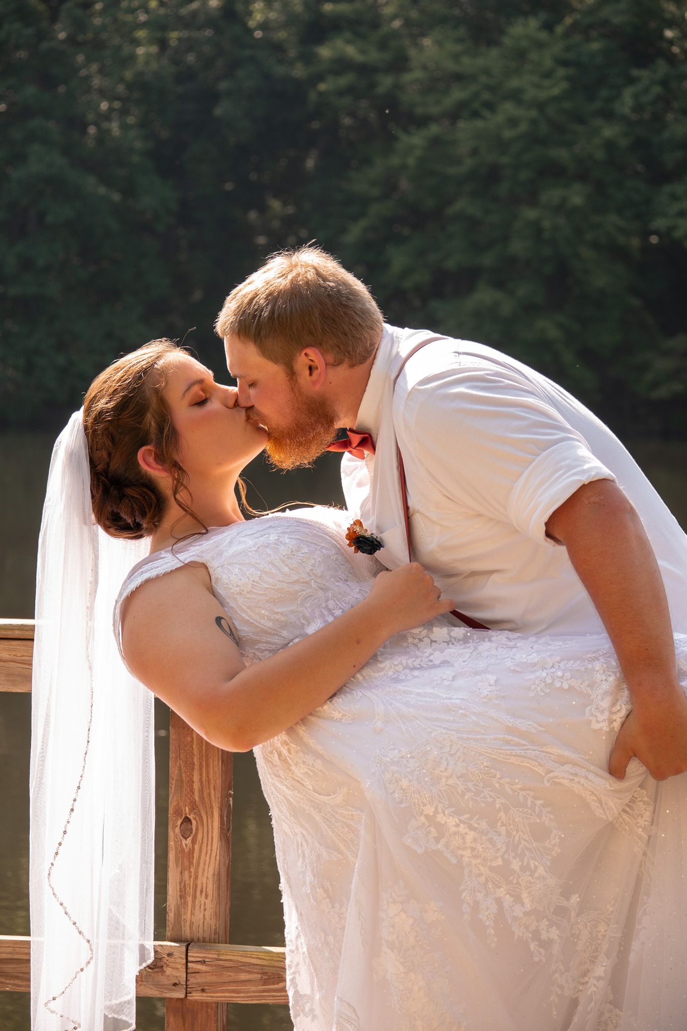 A romantic sequence of wedding photos showing a couple sharing a kiss on a wooden deck surrounded by trees.