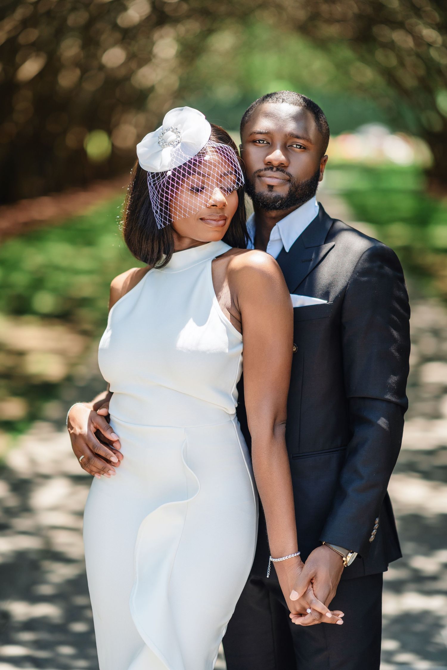 Romantic wedding portraits in a garden setting with soft natural lighting and bokeh effects.