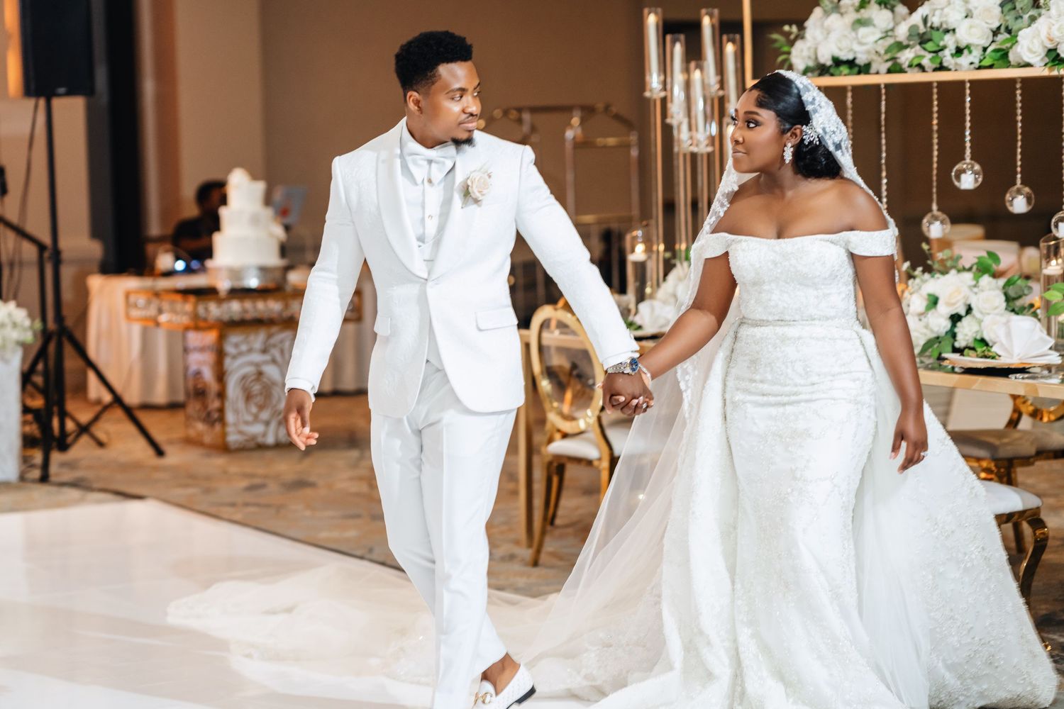 Elegant all-white wedding party lineup with coordinated formal attire.