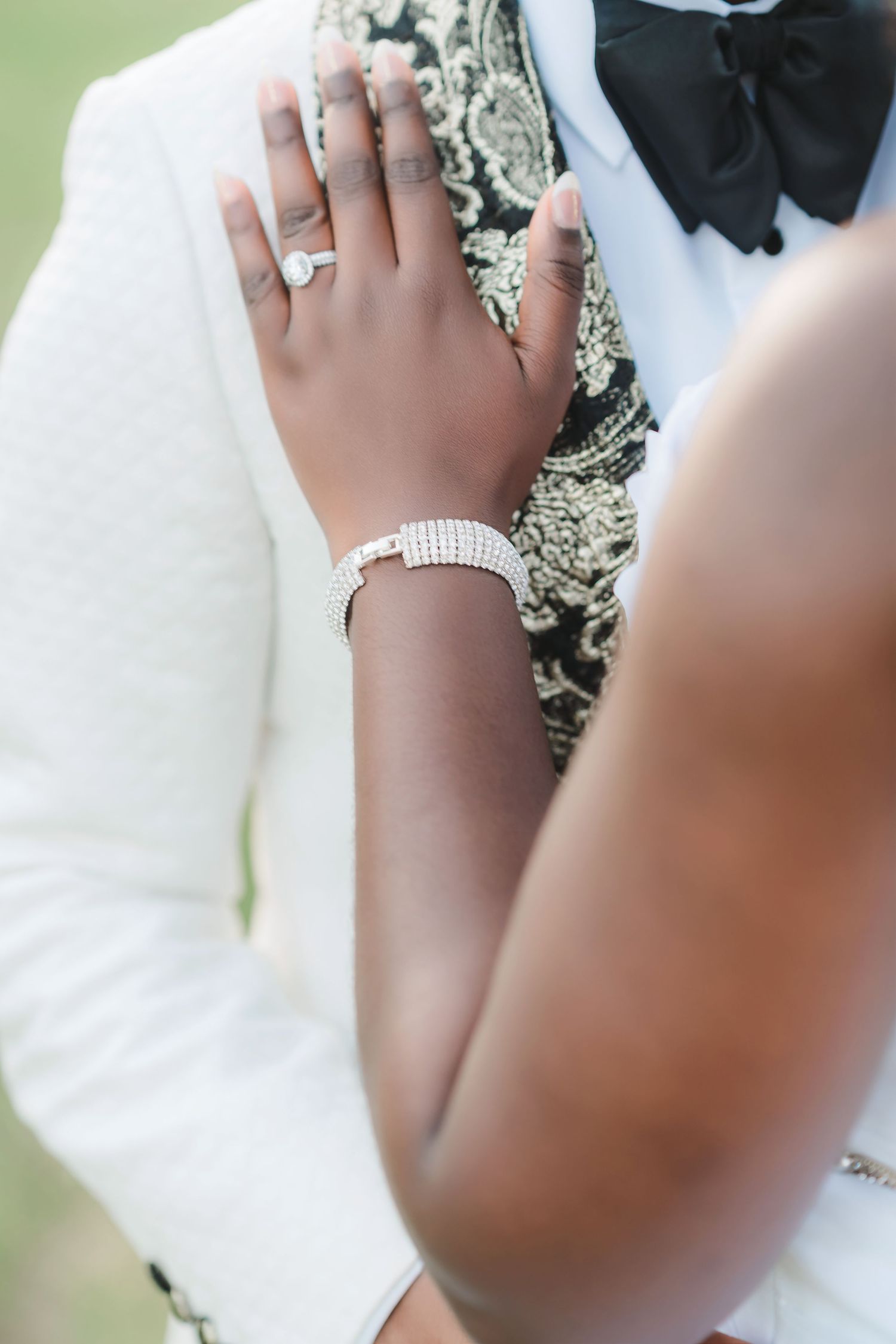 Wedding ring detail shots with white fabric and delicate jewelry accents.