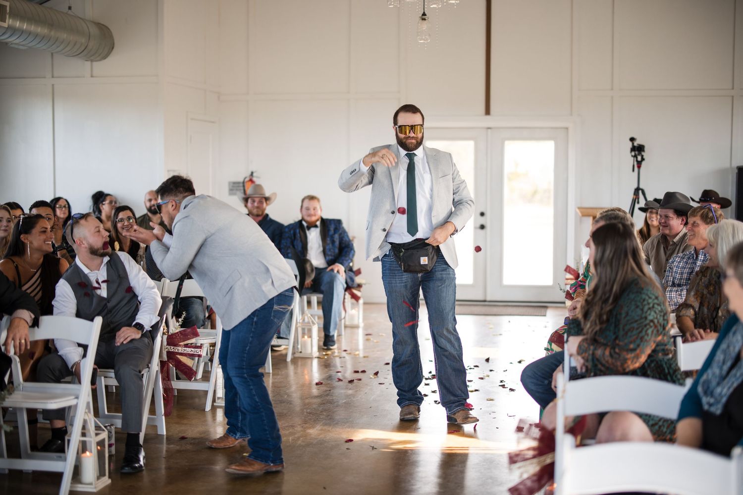 Wedding guests dance and celebrate during a lively indoor reception.