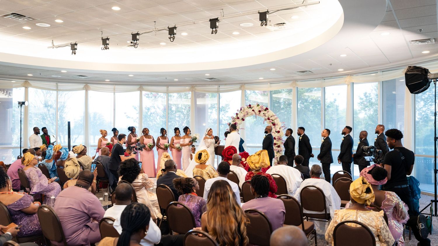 Wide shot of event venue showing panoramic windows and seated guests.