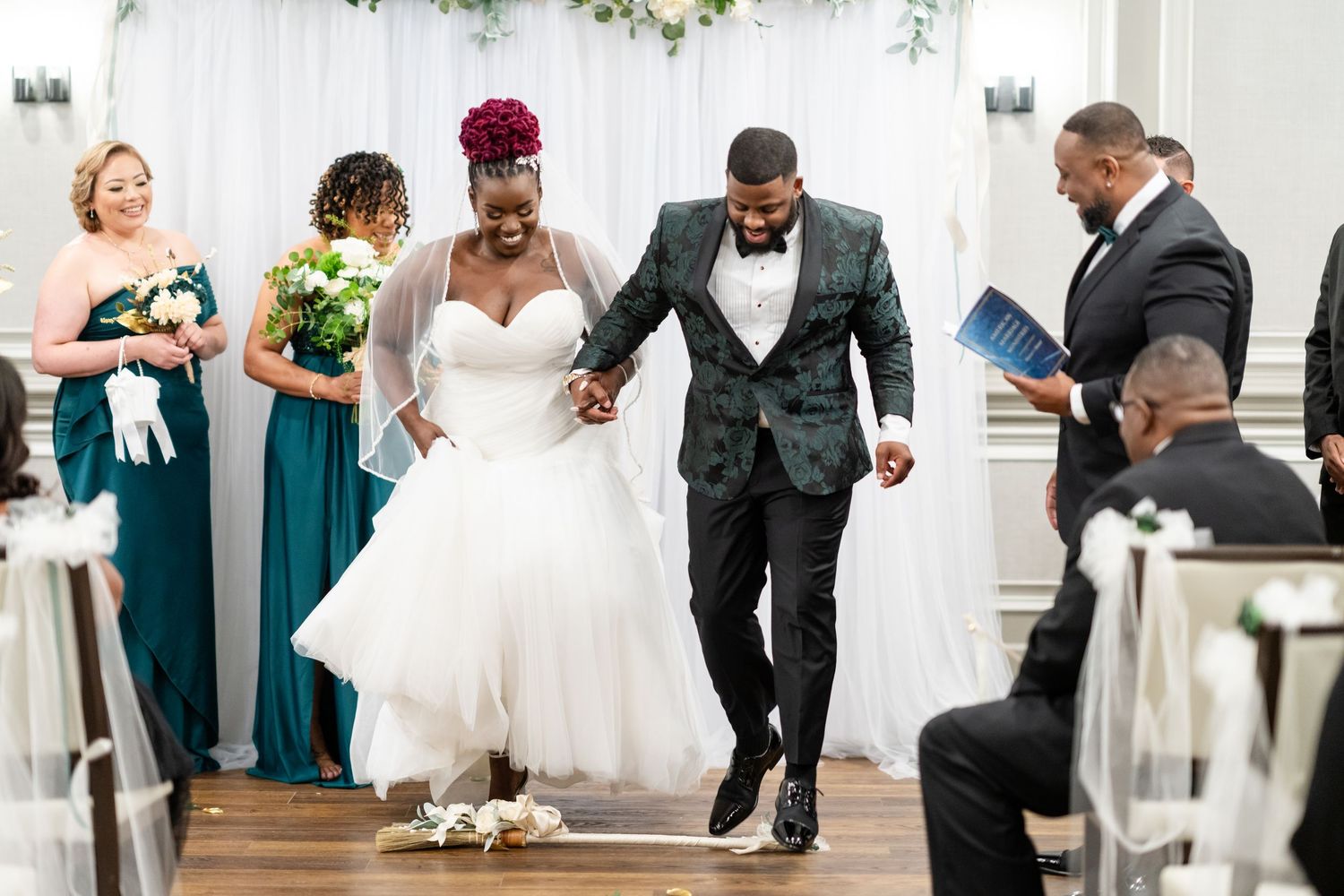 Wedding couple and guests dancing during reception celebration.