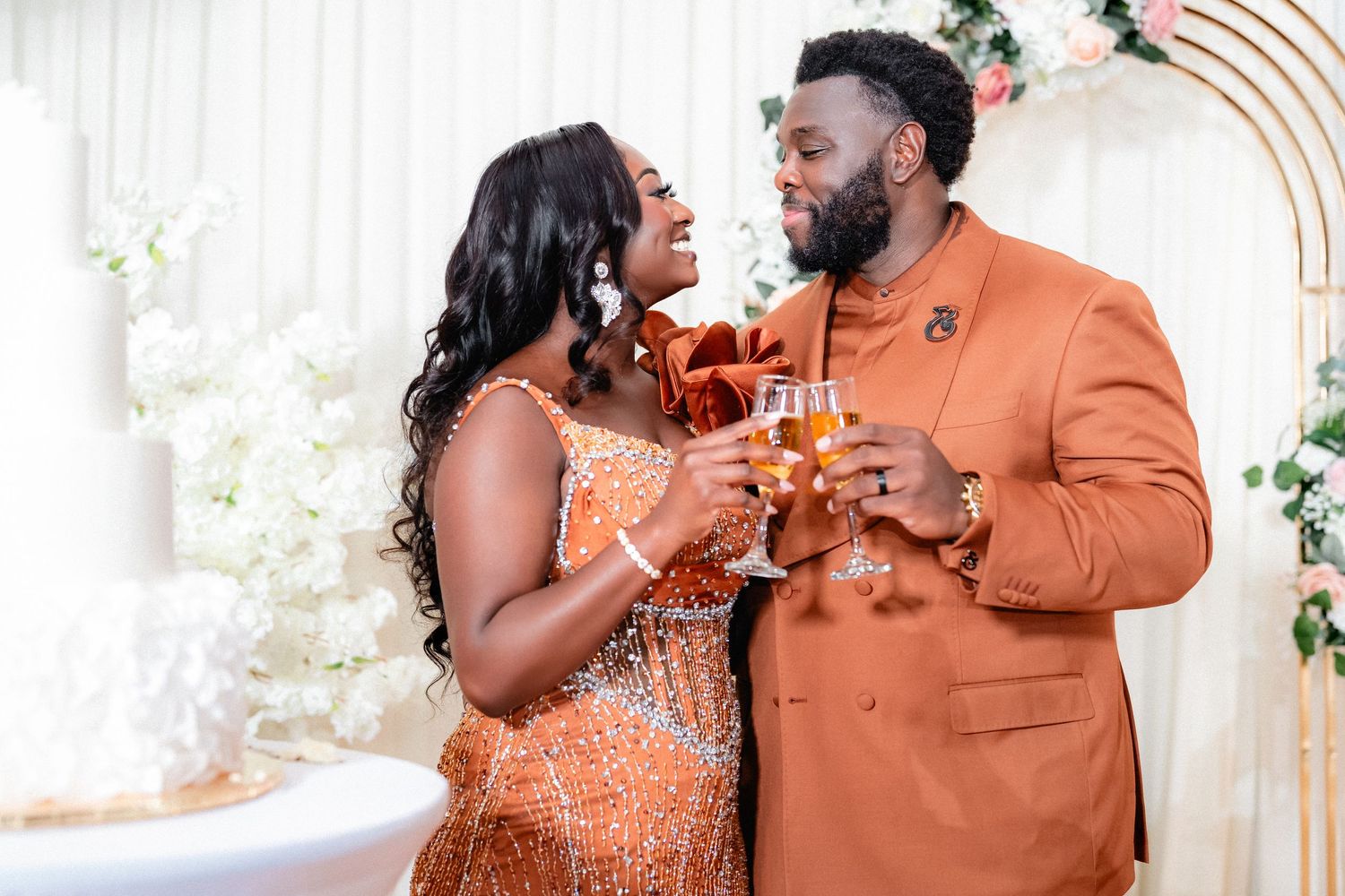 A couple celebrates their special moment at an elegant wedding reception with peach and white decor.