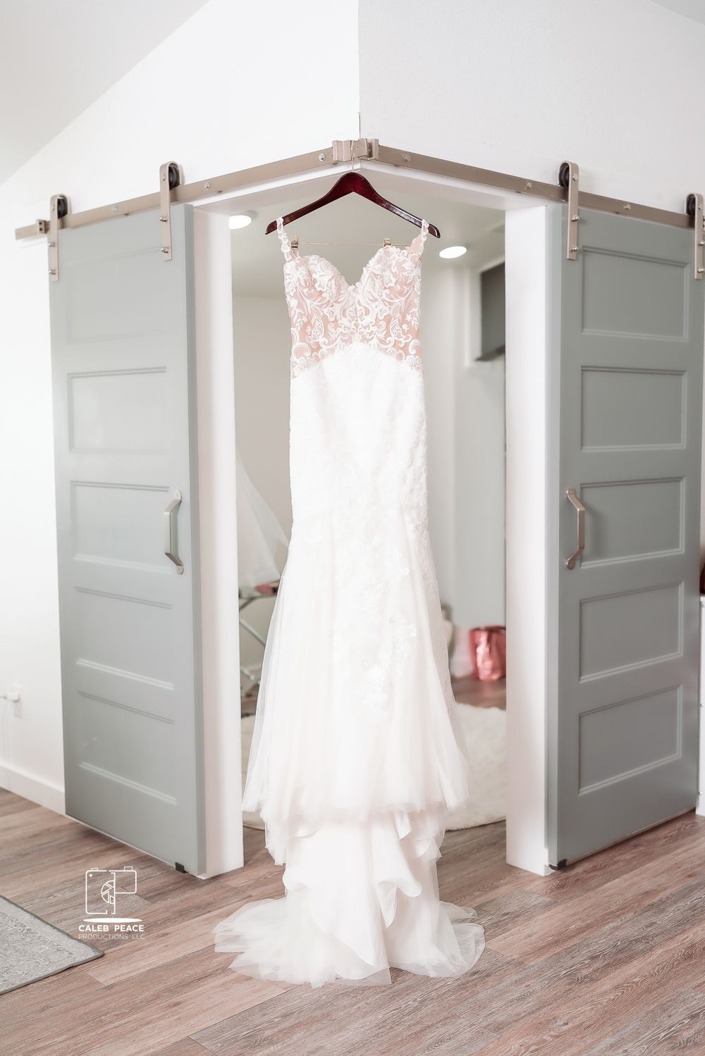 A white wedding dress hangs elegantly against a light gray door in a series of progressive photos showing different angles.