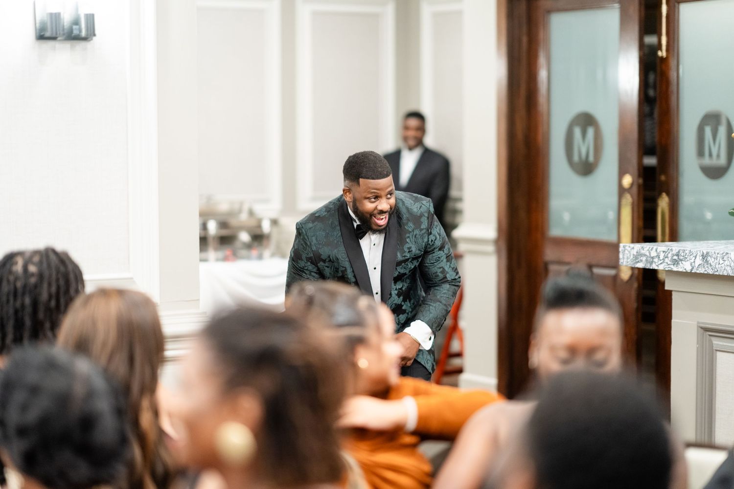 Wedding ceremony candid moments captured in elegant white indoor venue.