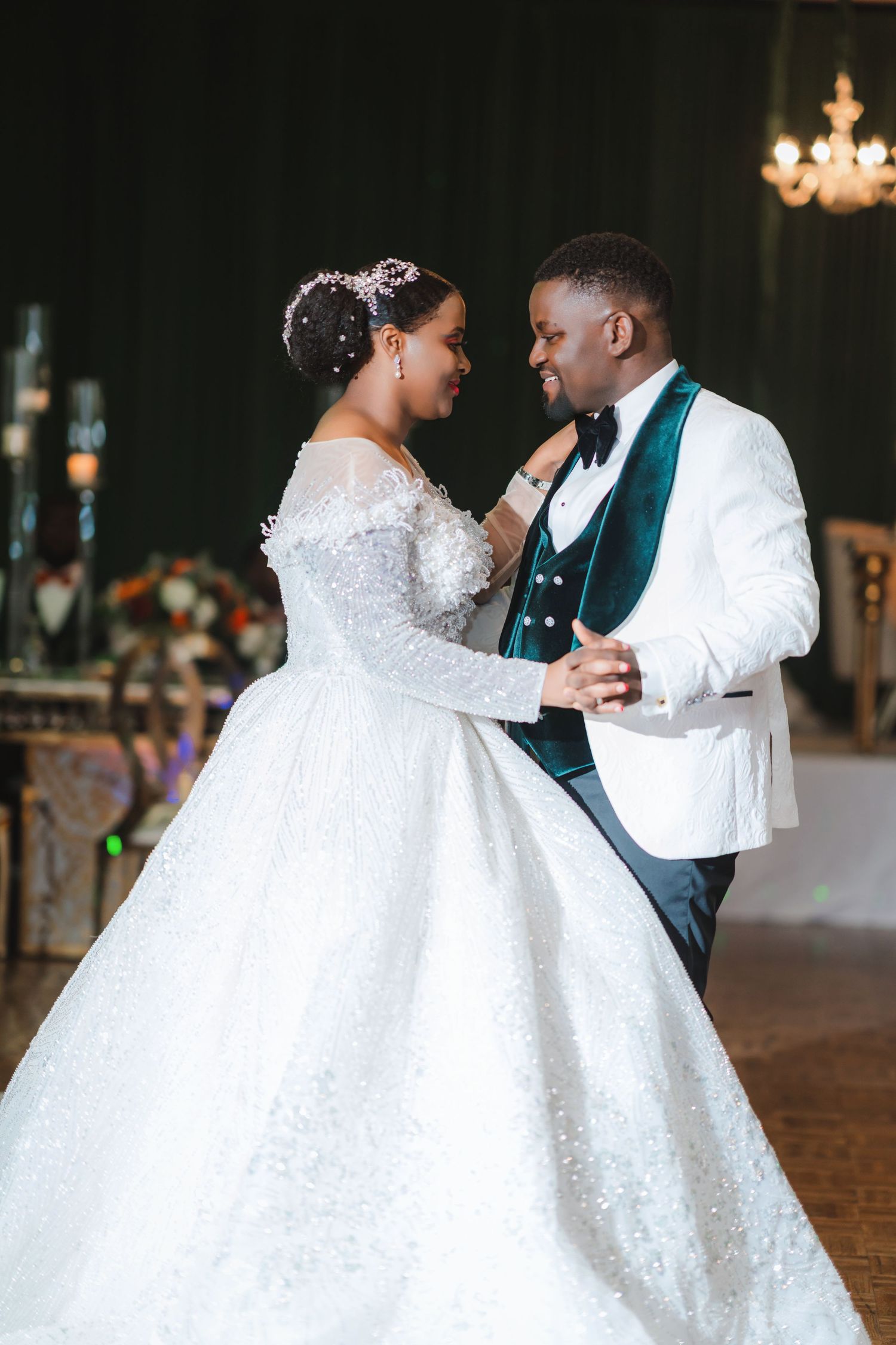 A romantic wedding dance scene with a flowing white ballgown and emerald green accents.