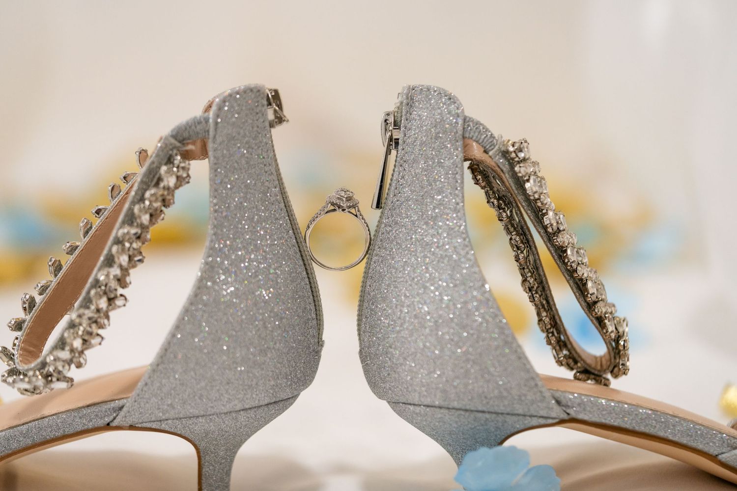 Close-up details of sparkly silver wedding shoes with rhinestone embellishments.