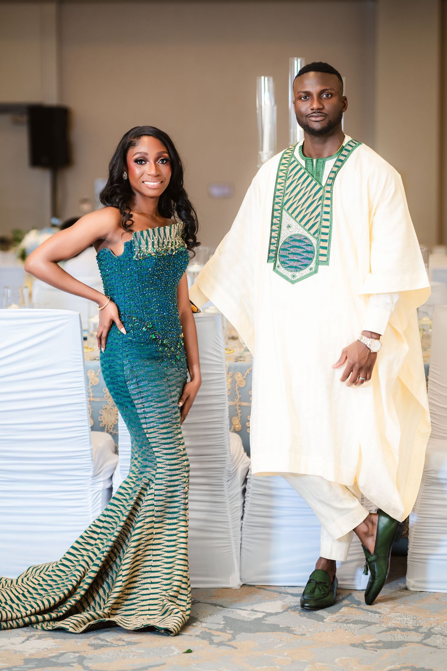 Wedding couple posing together in traditional attire with teal and white color scheme.