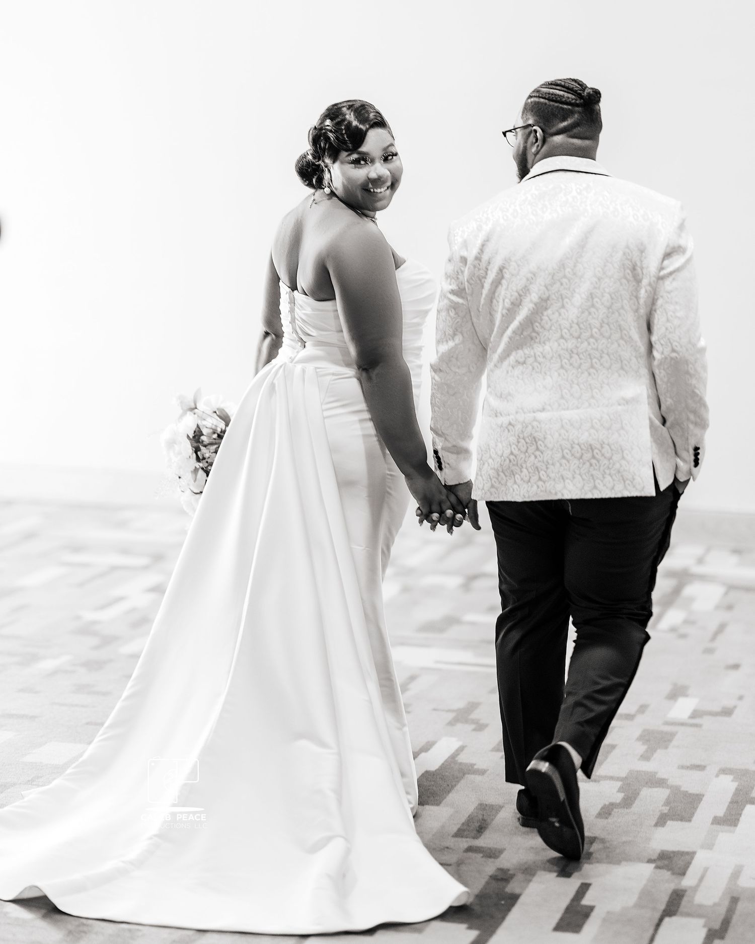 Black and white wedding photos showing a couple walking together in formal attire.