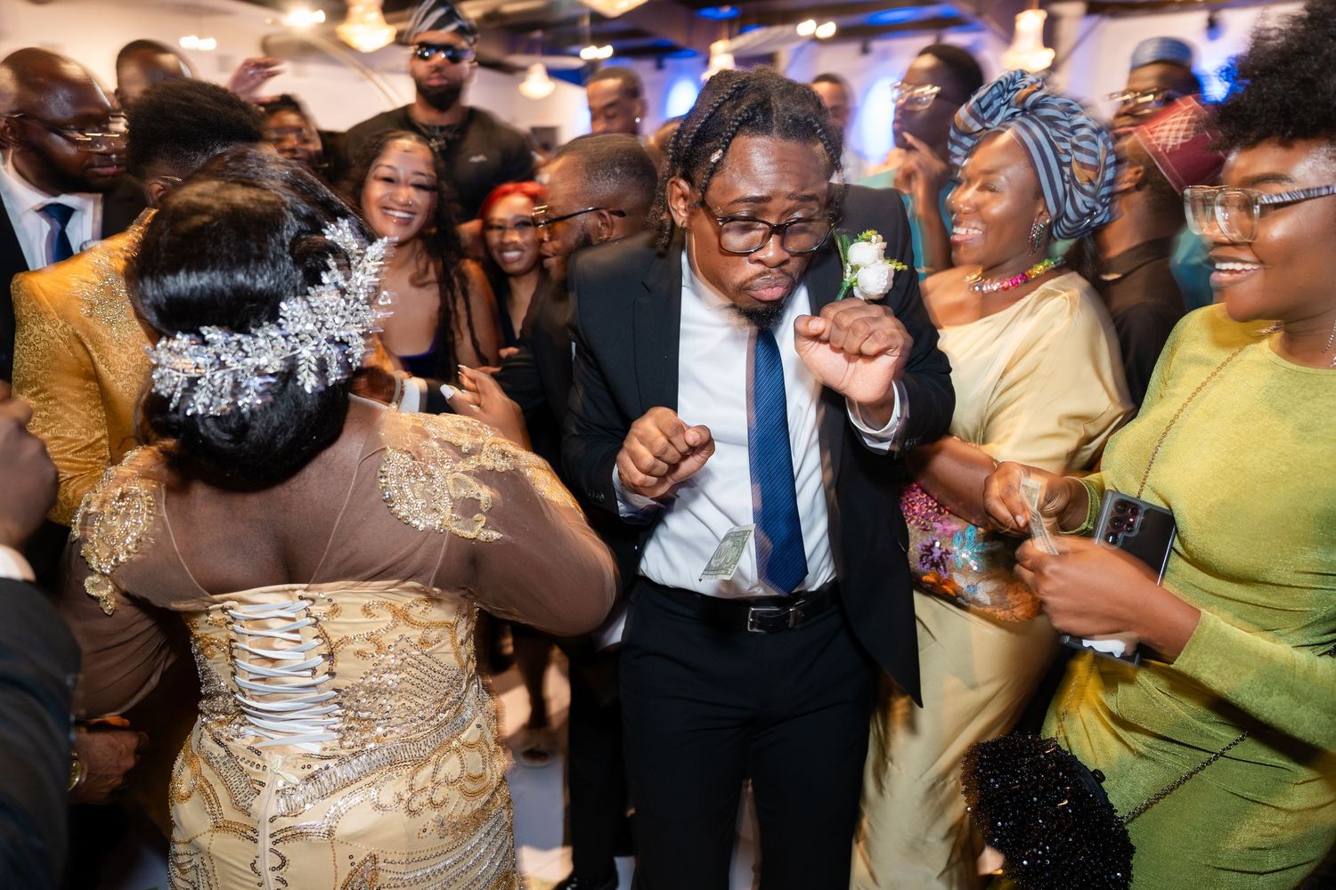 Wedding guests dancing and celebrating at an energetic reception party.